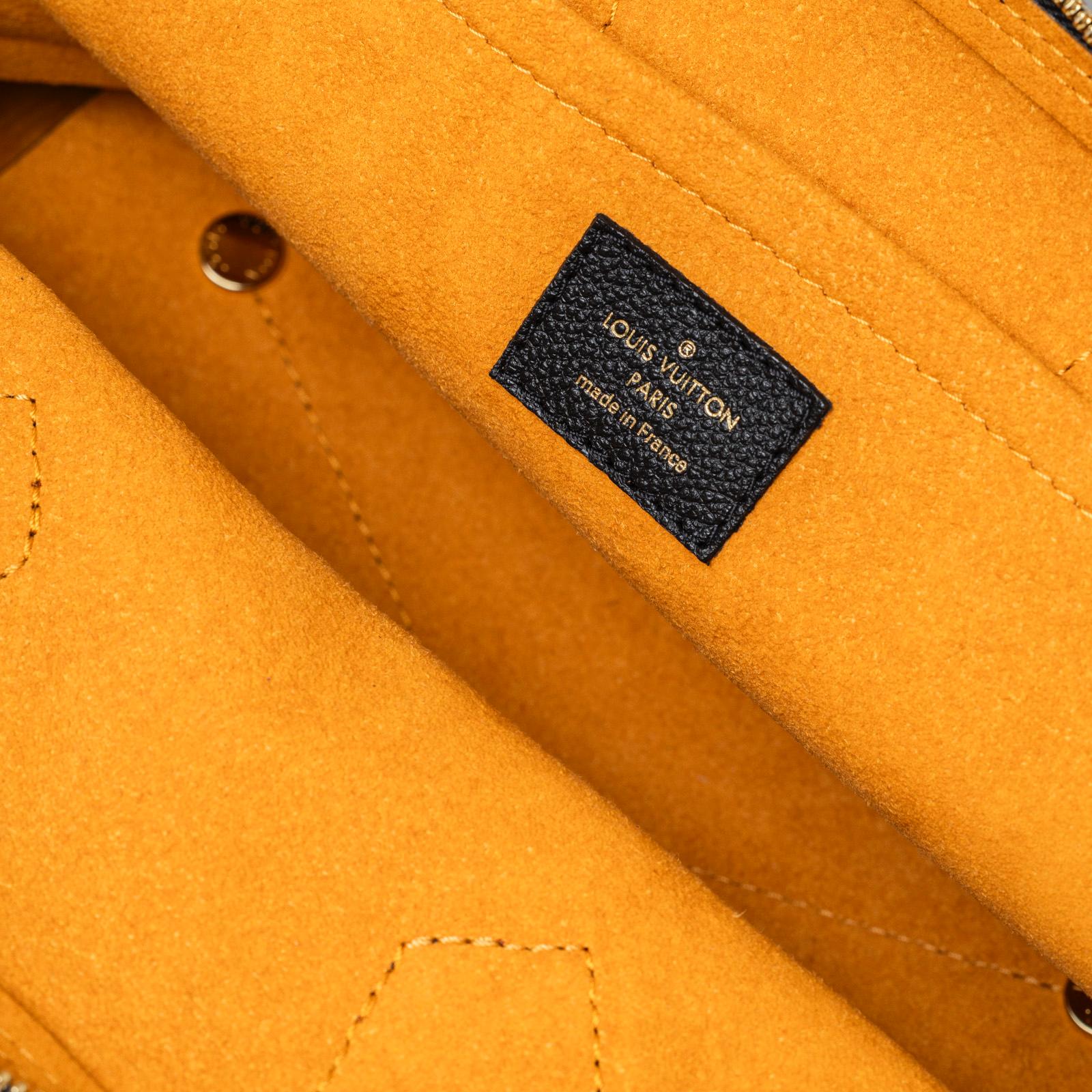 Inside shot of Louis Vuitton Neo Alma BB Monogram Empreinte Black Gold hardware