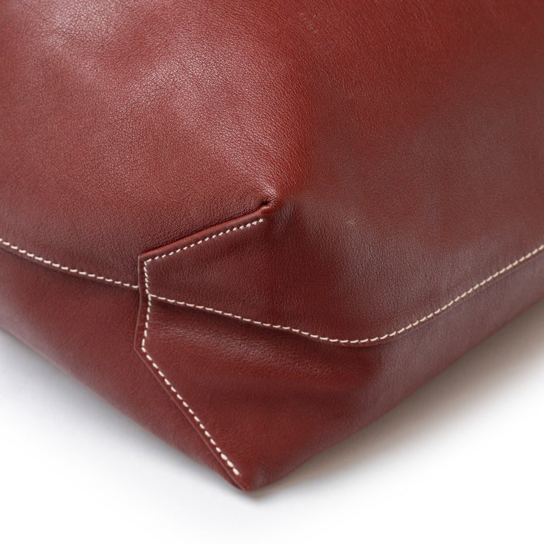 Close-up of stitching detail on corner of Hermès Double Sens 45 Rouge/Bicolor Swift leather bag