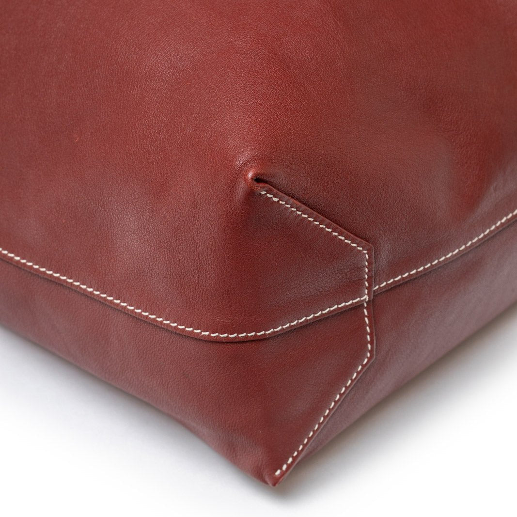 Close-up of corner stitch detail on Hermès Double Sens 45 Rouge/Bicolor Swift leather bag