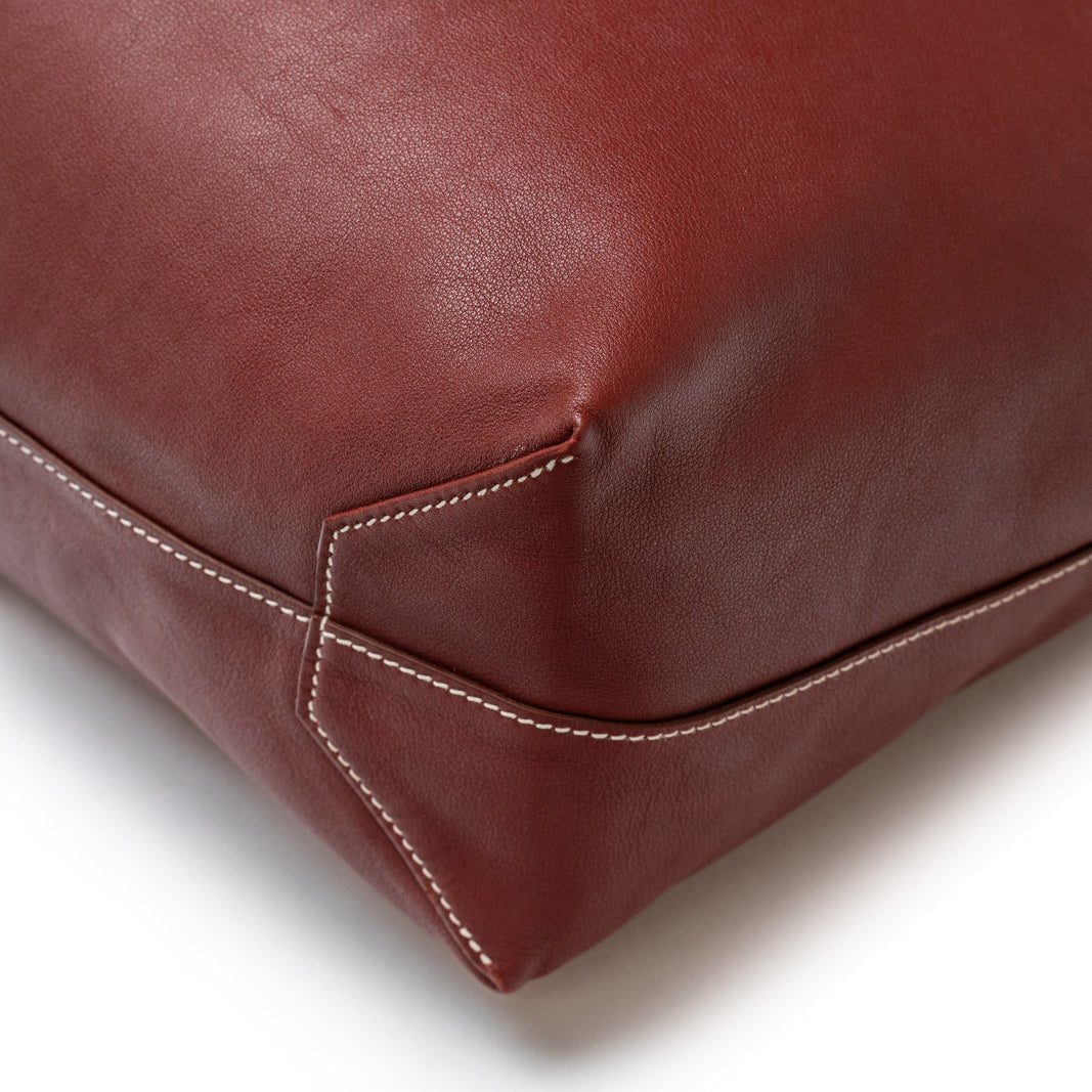 Close-up of corner stitching detail on Hermès Double Sens 45 Rouge/Bicolor Swift leather bag showing craftsmanship