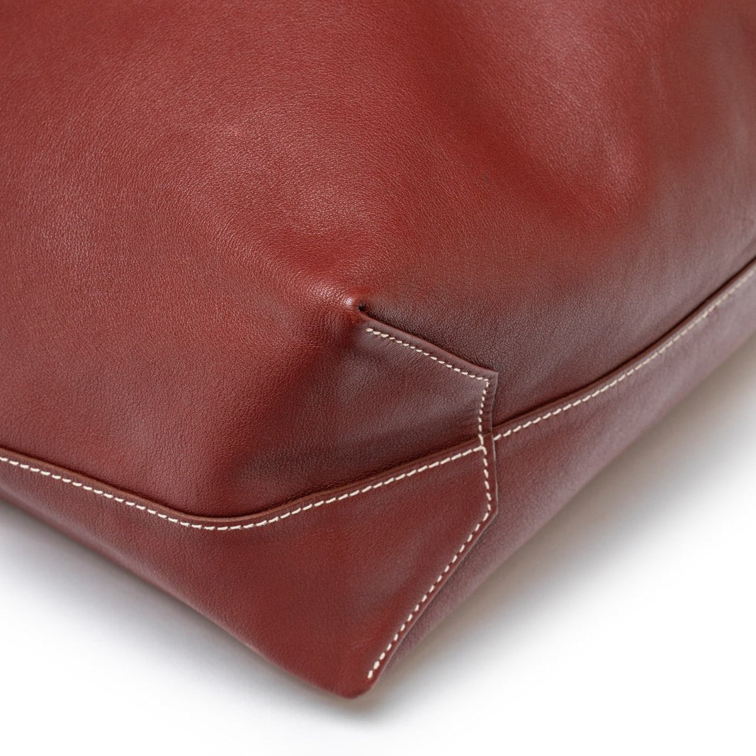 Close-up detail of bottom corner stitching on Hermès Double Sens 45 Rouge/Bicolor Swift leather bag