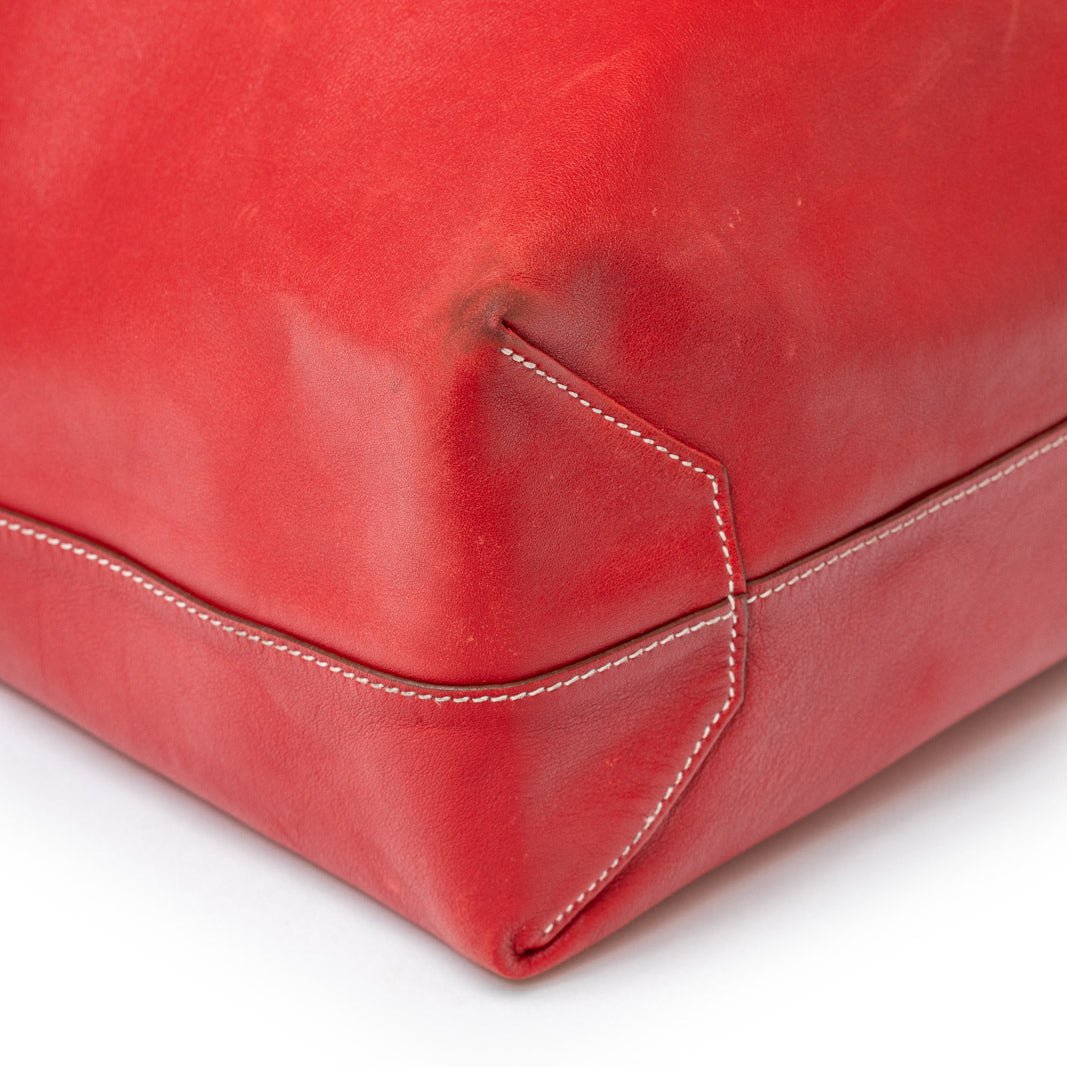 Close-up of corner stitching detail on Hermès Double Sens 45 Rouge/Bicolor Swift leather bag showing quality craftsmanship