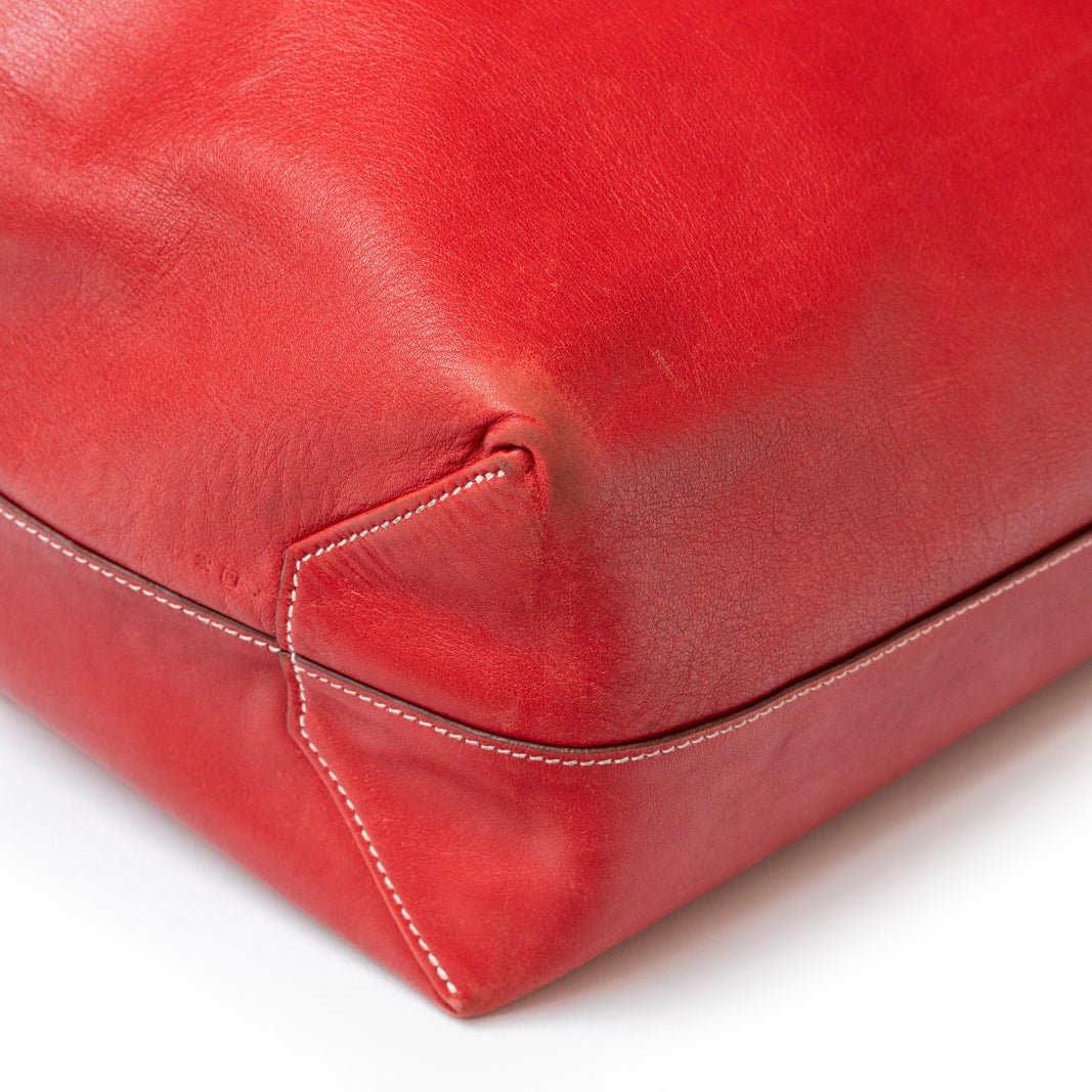 Close-up of corner stitching detail on Hermès Double Sens 45 Rouge/Bicolor Swift leather bag in red tone