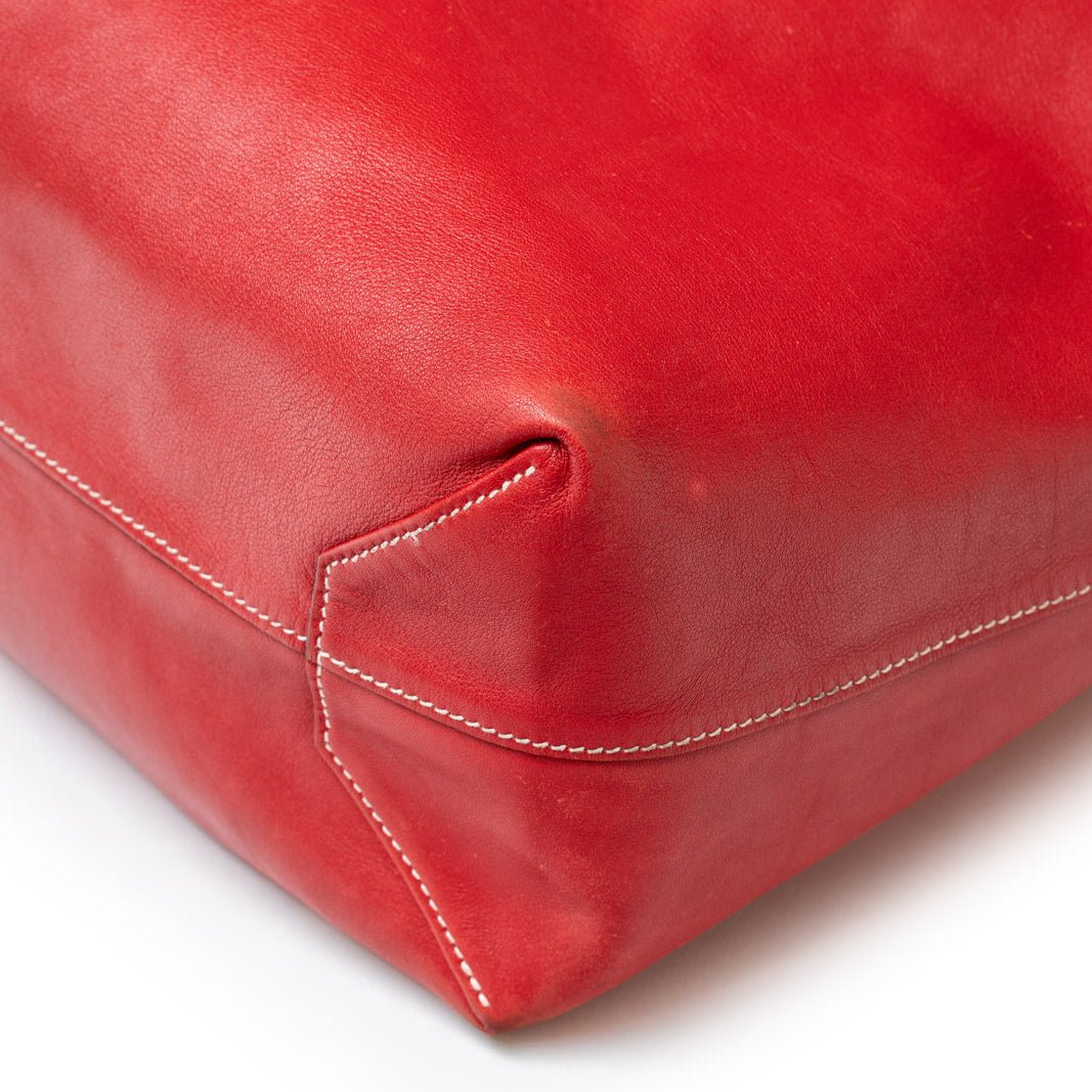 Close-up of corner stitching detail on Hermès Double Sens 45 Rouge/Bicolor Swift leather bag in red tone