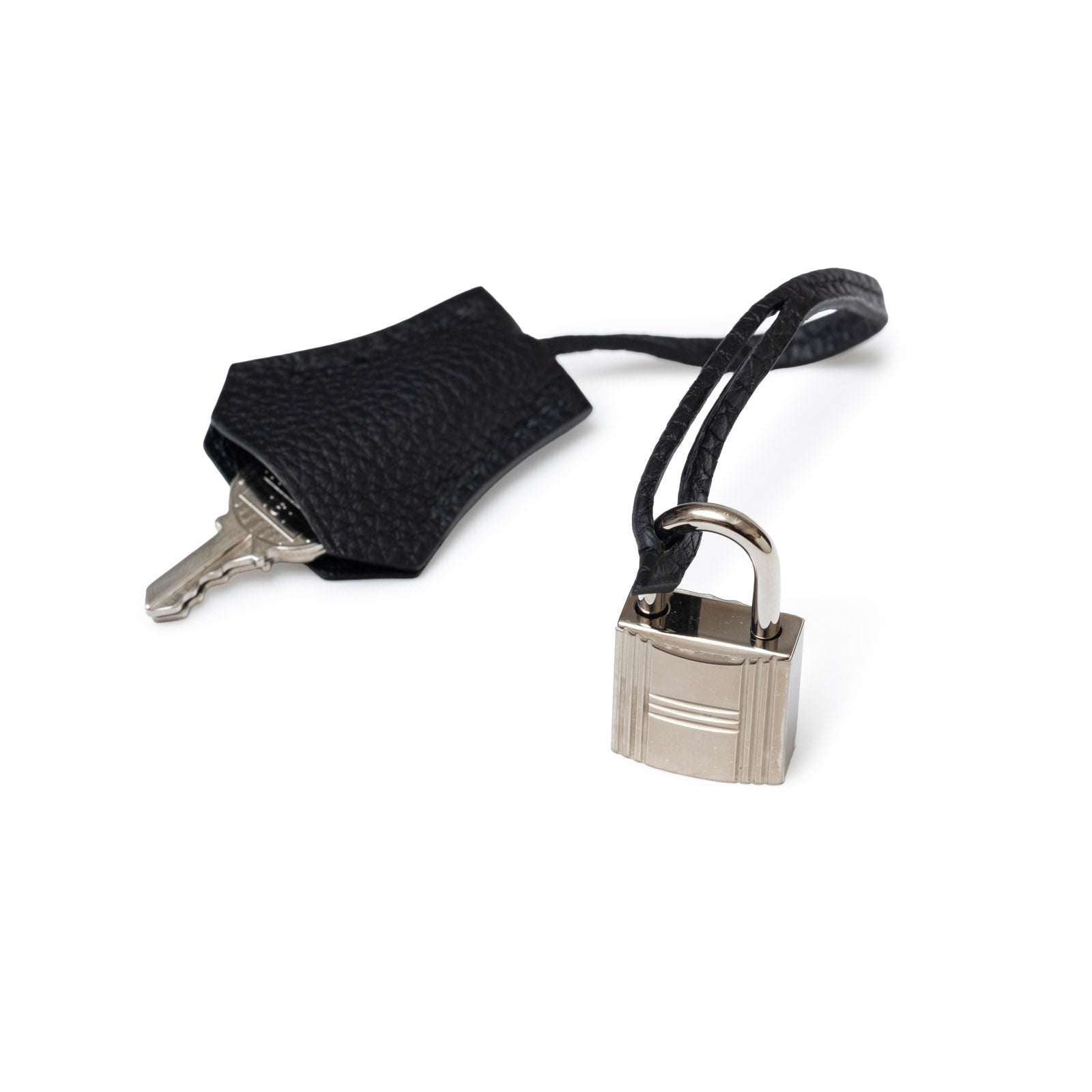 Close-up of palladium padlock and black togo leather key holder for Hermès Birkin 25 Black Togo Palladium Hardware.
