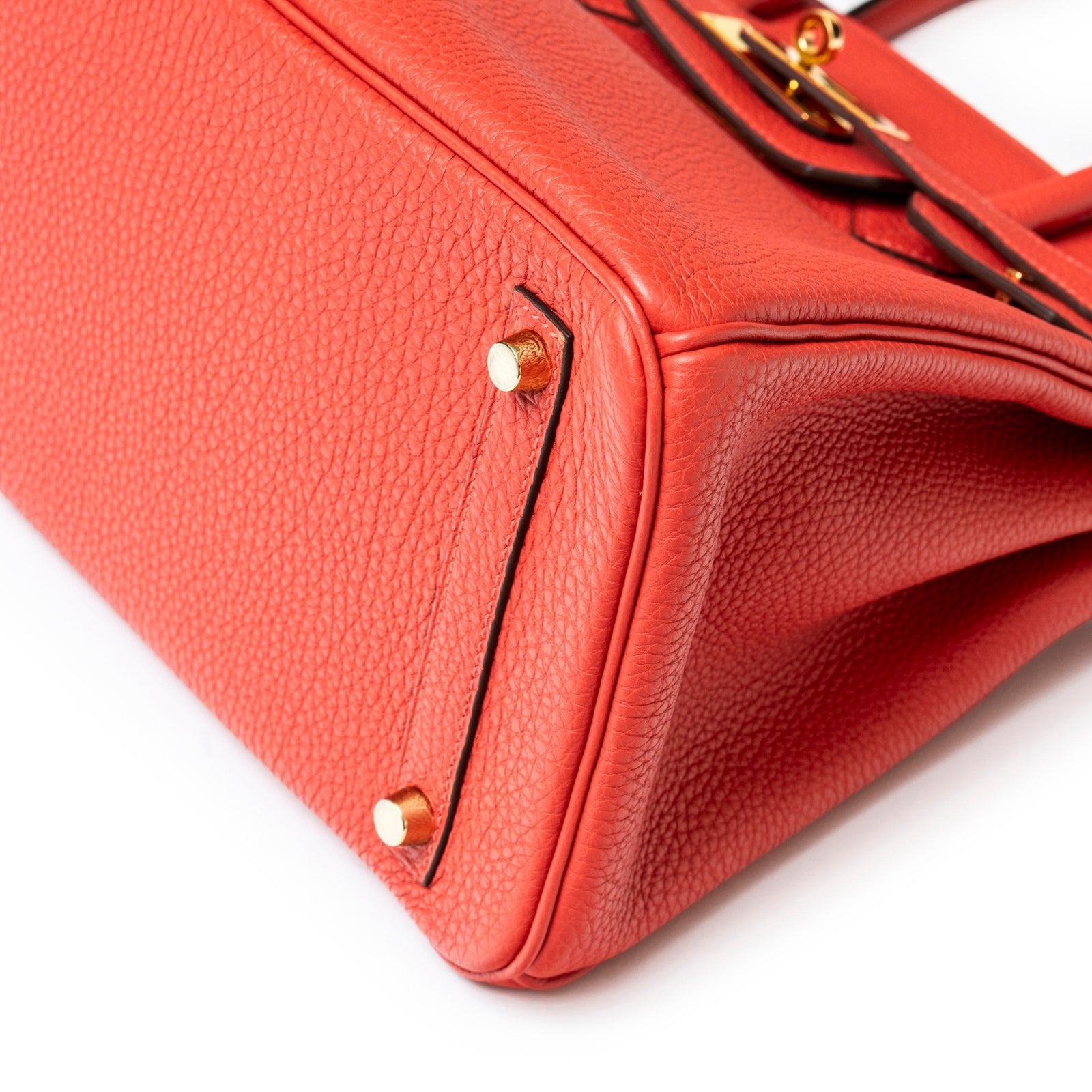 Close-up of bottom corner with gold hardware on Hermès Birkin 30 Rouge Pivoine Clemence Gold Hardware bag