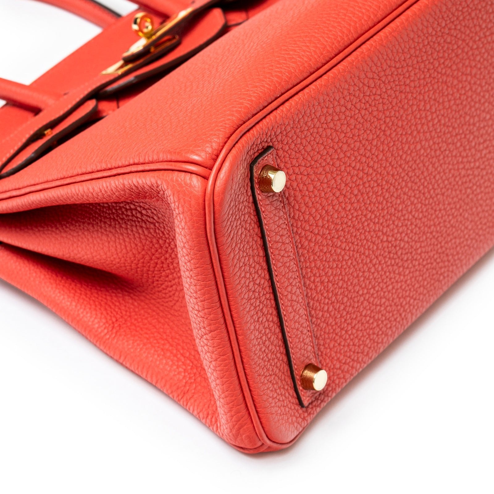 Close-up view of the bottom corner showing texture and gold hardware on Hermès Birkin 30 Rouge Pivoine Clemence Gold Hardware