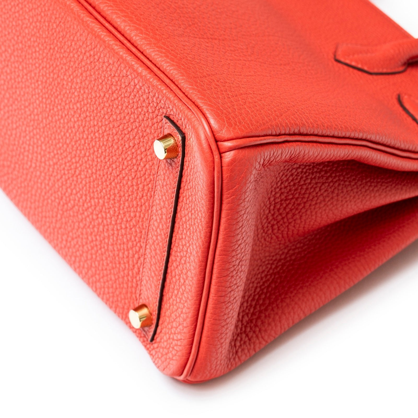 Close-up of bottom corner and gold hardware on Hermès Birkin 30 Rouge Pivoine Clemence Gold Hardware bag