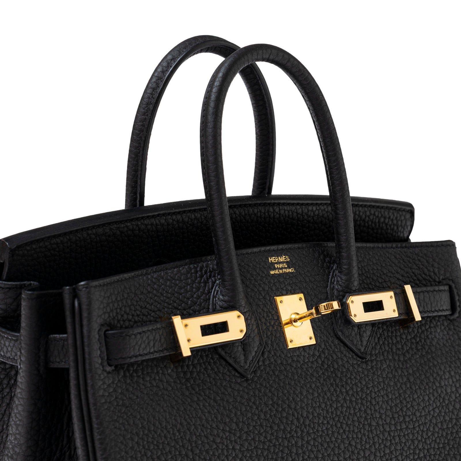 Close-up angled shot of Hermès Birkin 25 Black Togo Gold Hardware showing textured leather and gold clasp details.