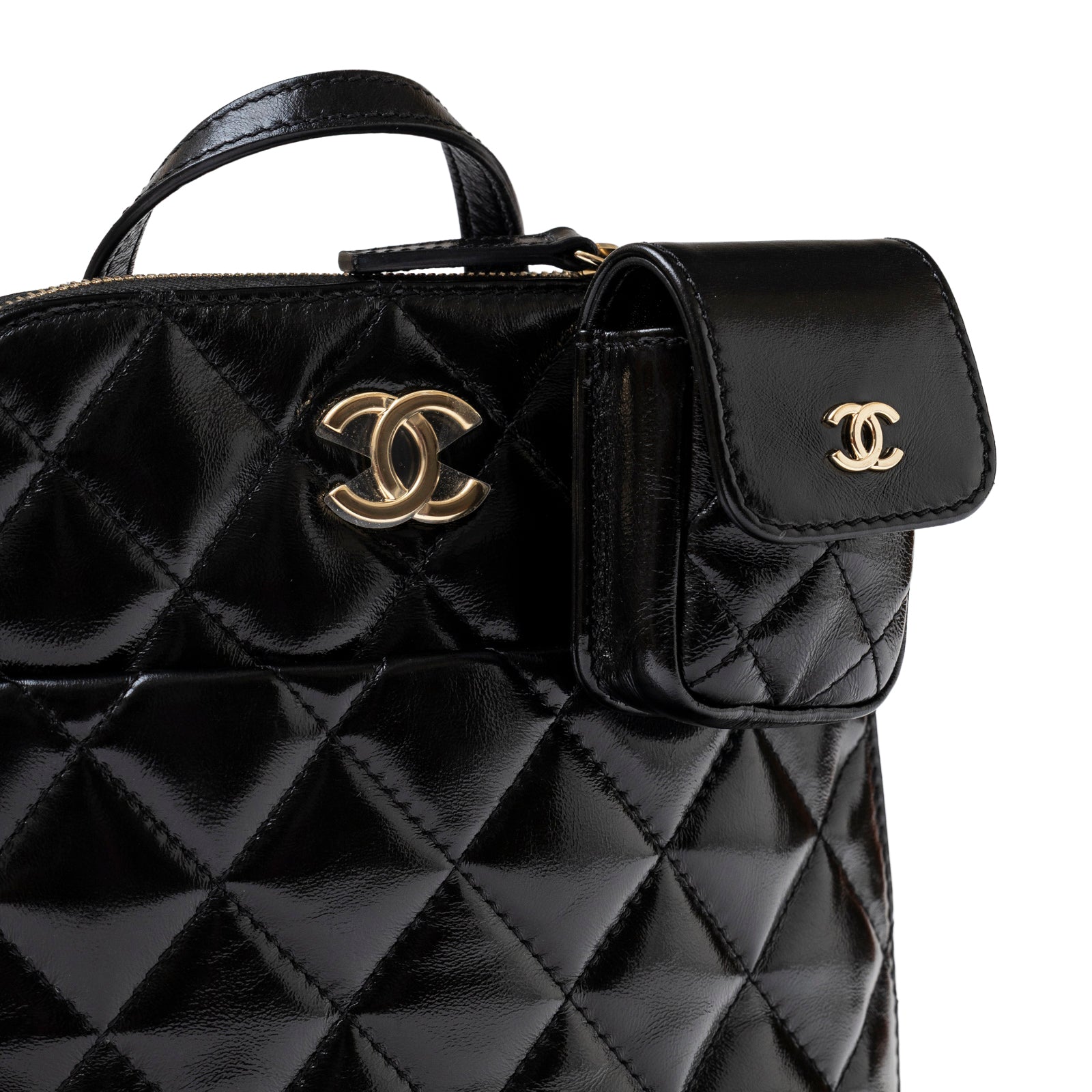 Close-up of Chanel My Pocket Backpack Black Shiny Calfskin Gold Hardware showing quilted texture and gold logo clasp detail