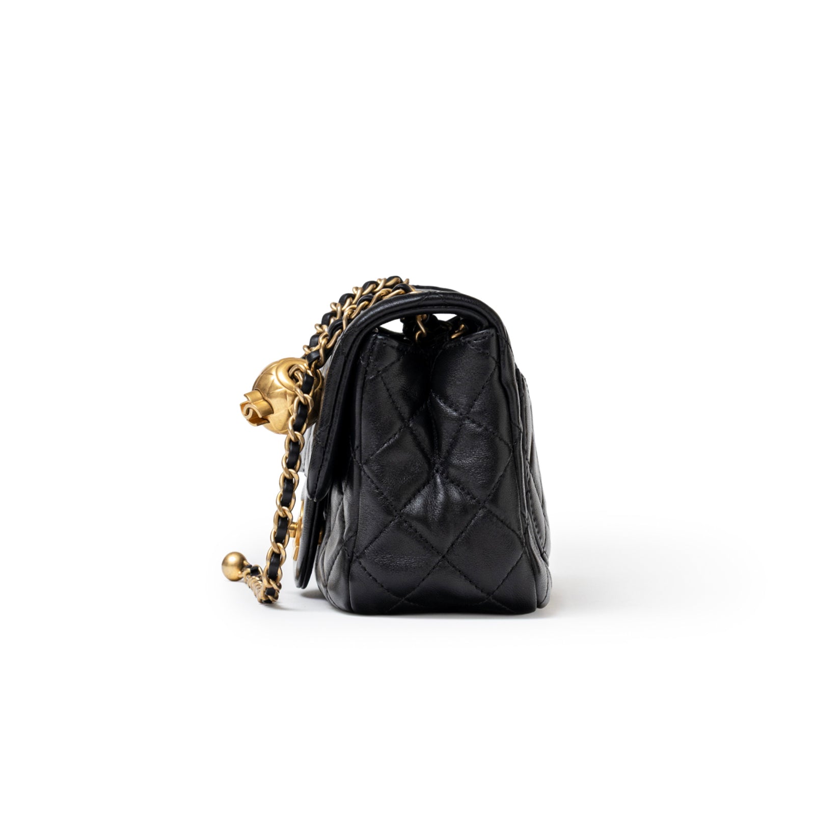 Side view of Chanel Mini Square Pearl Crush Flap Bag Black Lambskin Aged Brushed Gold Hardware showing quilted texture and chain detail