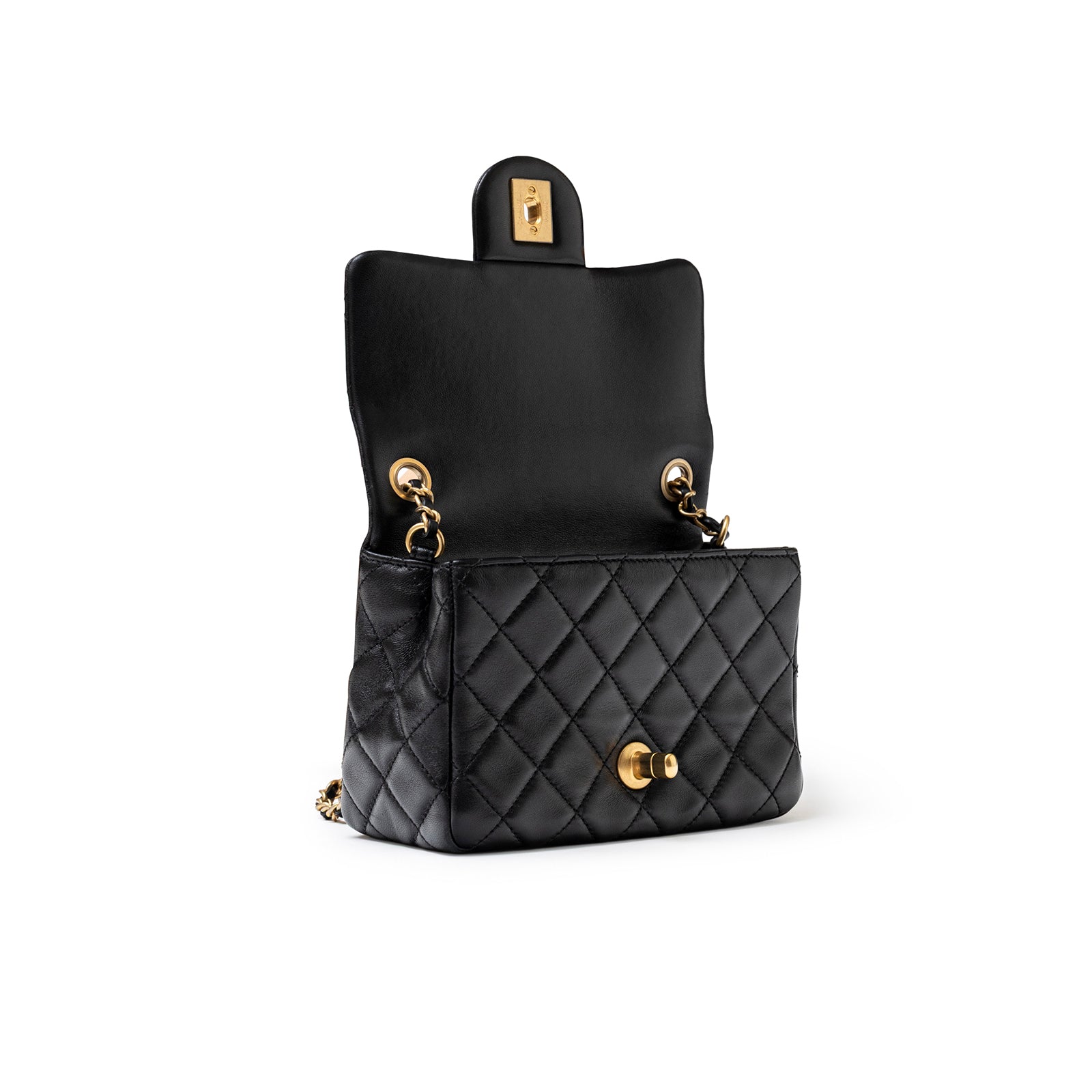 Angled open view of Chanel Mini Square Pearl Crush Flap Bag Black Lambskin Aged Brushed Gold Hardware showing interior and quilting detail