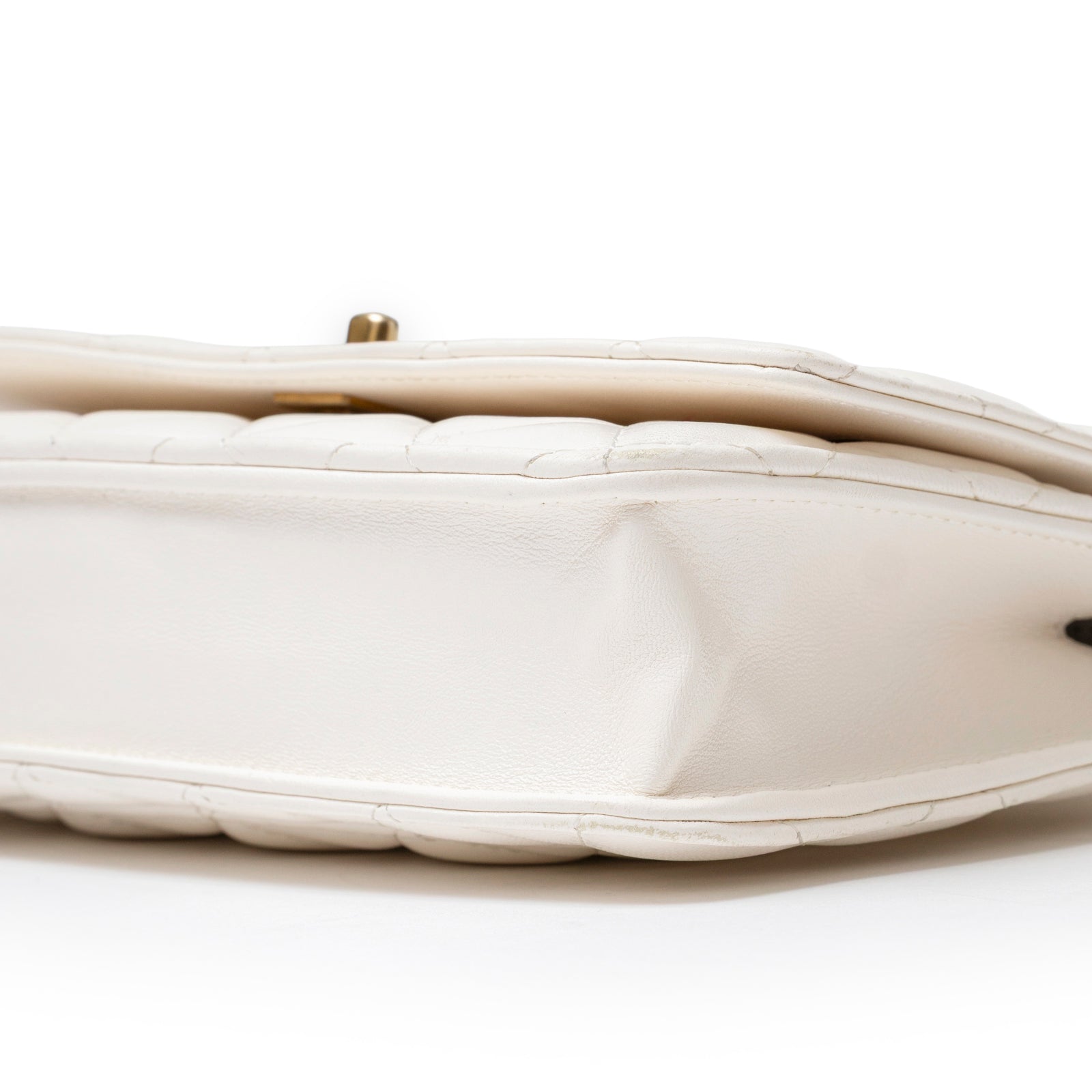 Close-up side view of Chanel CC Pearl Crush Wallet on Chain WOC Quilted Lambskin White Brushed Gold Hardware showing stitching and leather texture