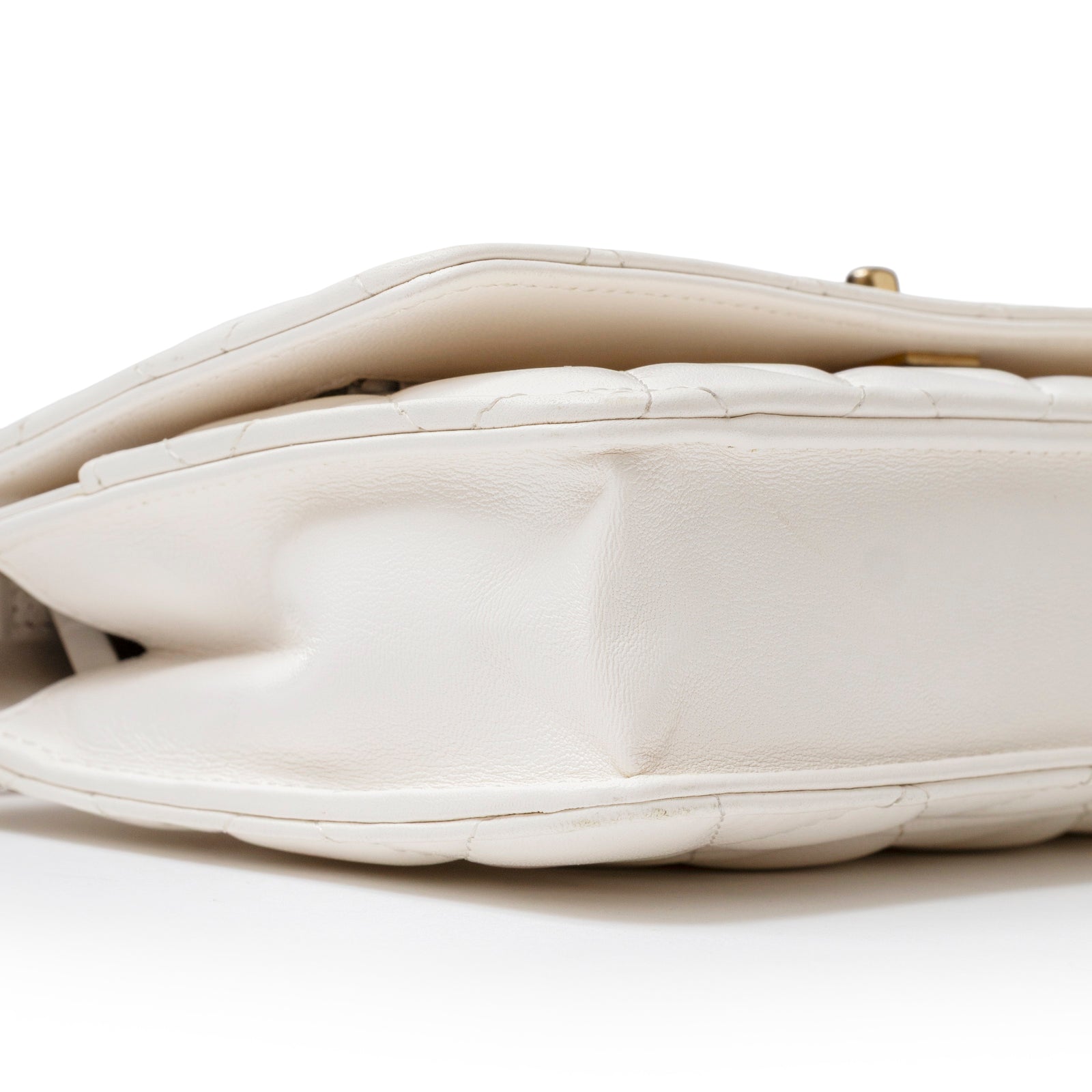 Close-up side view of Chanel CC Pearl Crush Wallet on Chain WOC Quilted Lambskin White Brushed Gold Hardware showing soft leather texture