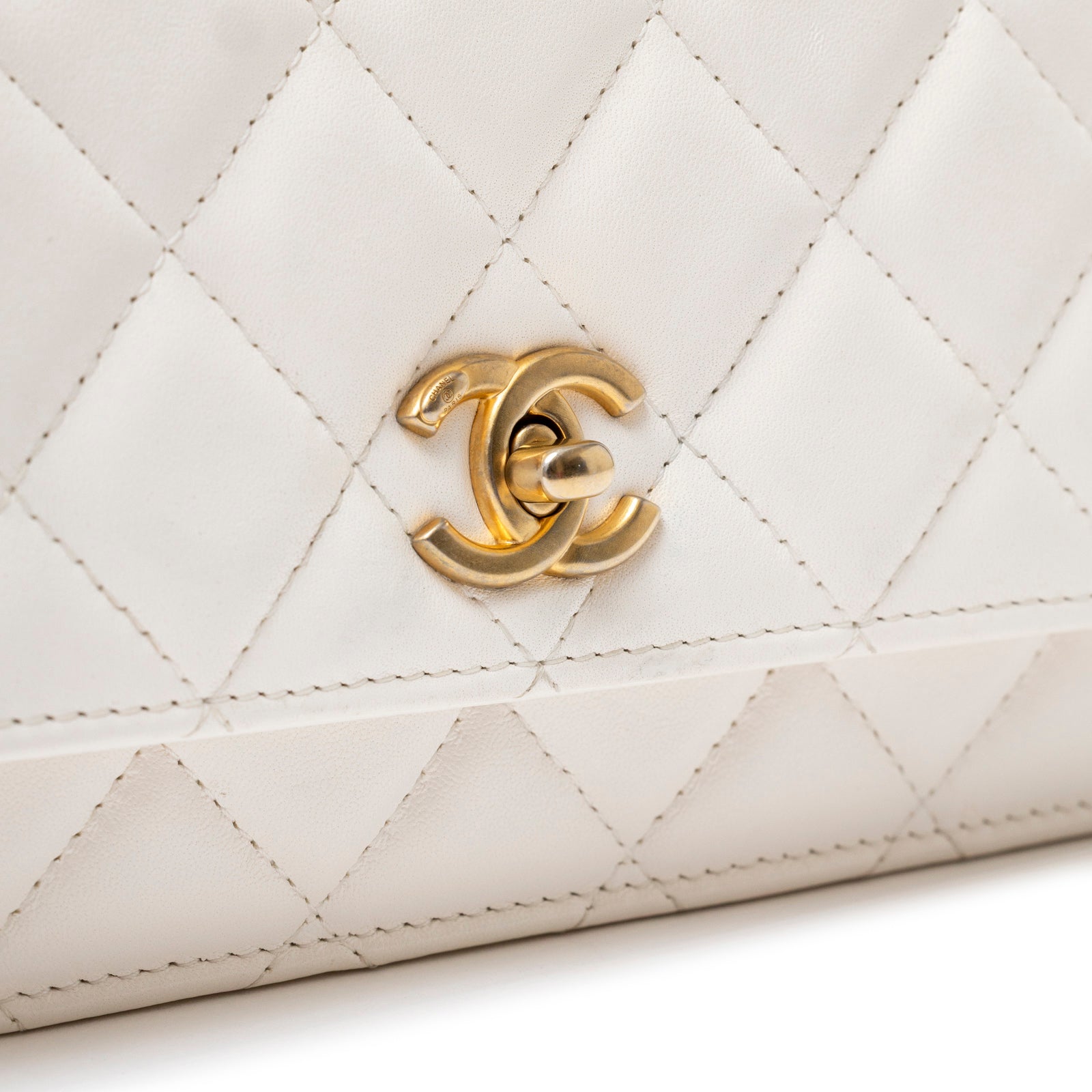 Close-up of brushed gold CC clasp on Chanel CC Pearl Crush Wallet on Chain WOC Quilted Lambskin White Brushed Gold Hardware