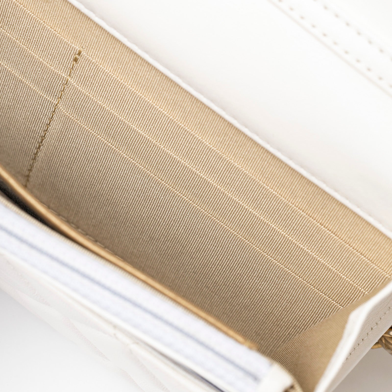 Interior view of Chanel CC Pearl Crush Wallet on Chain WOC Quilted Lambskin White Brushed Gold Hardware showing card slots and fabric lining