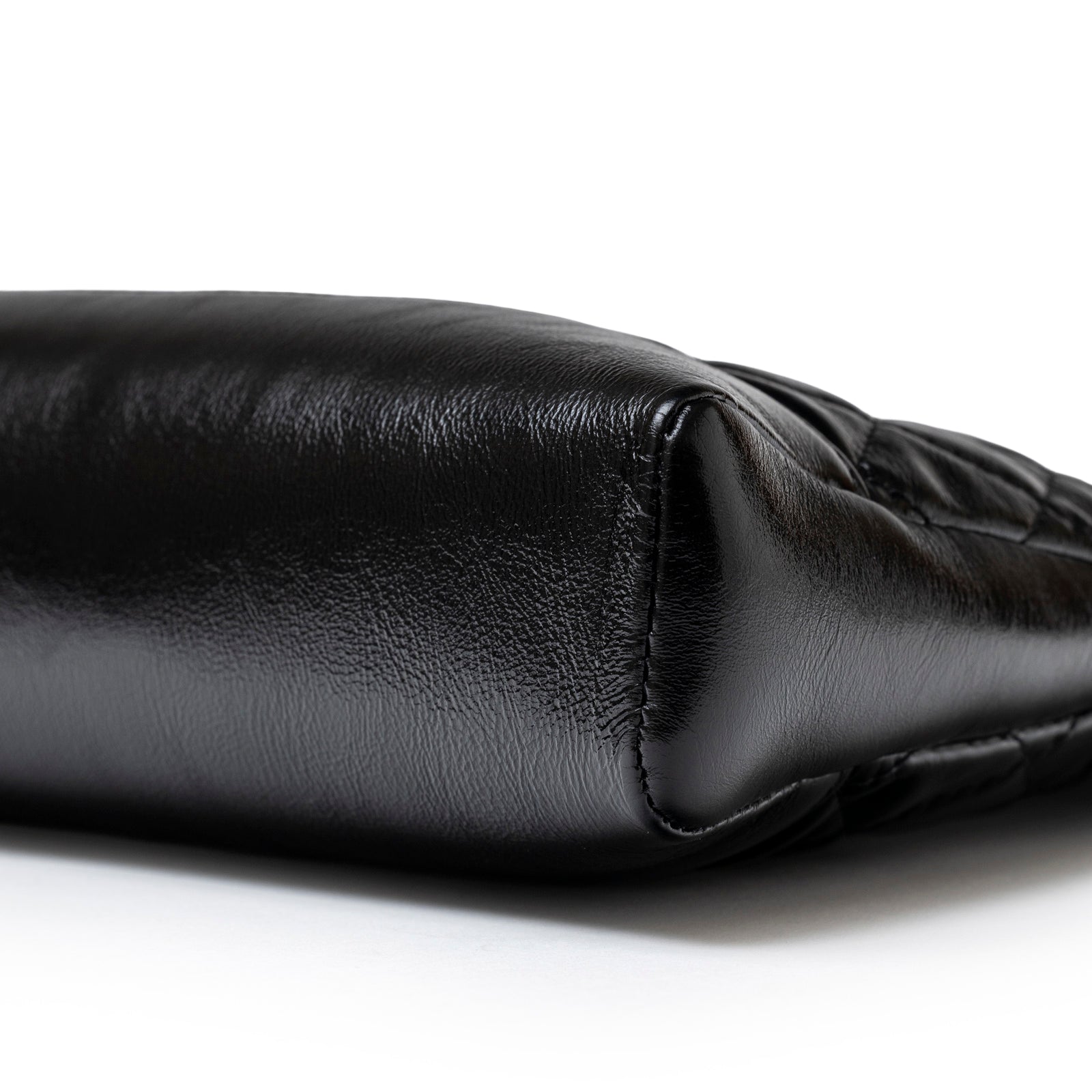 Close-up of bottom corner showing black calfskin texture on Chanel Mini 31 Shopping Tote Calfskin Black Gold Hardware