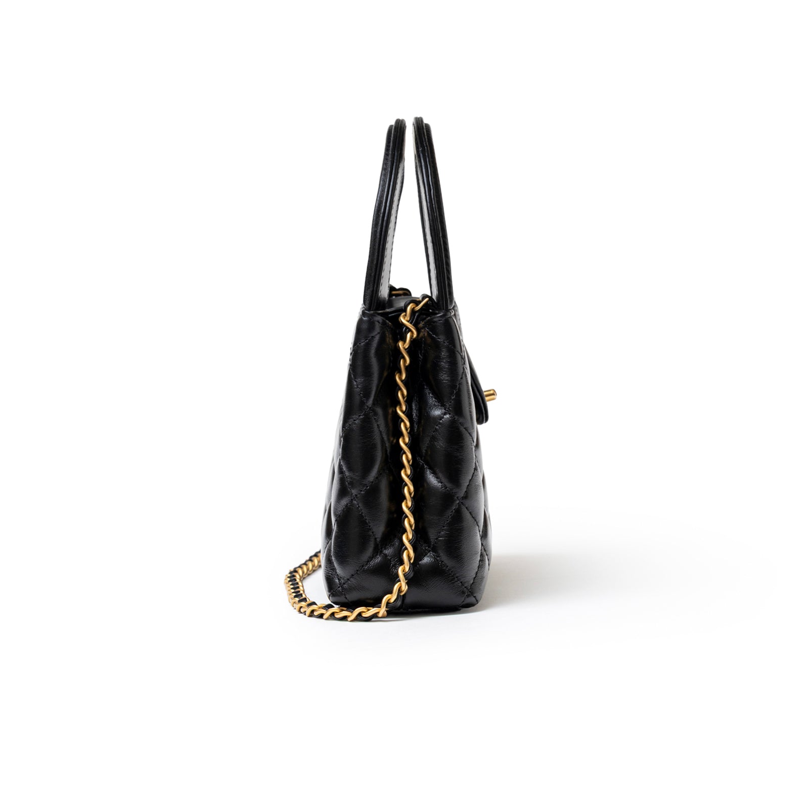 Side view of Chanel Mini Kelly Shopper Black Shiny Aged Calfskin Brushed Gold Hardware with chain strap detail