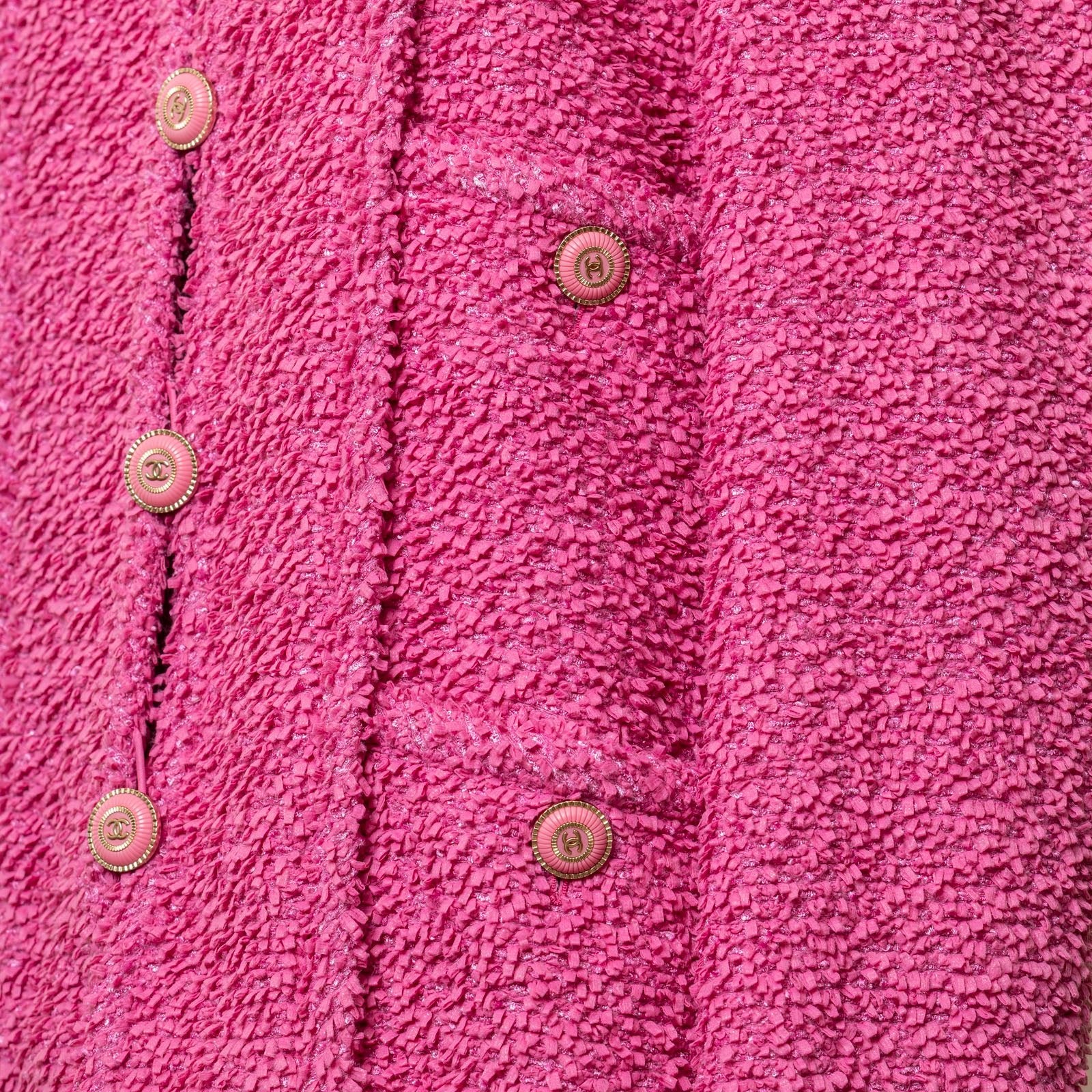 Close-up of textured fabric and branded buttons on Chanel Tweed Jacket Victoria Ceretti Fushia detail panel