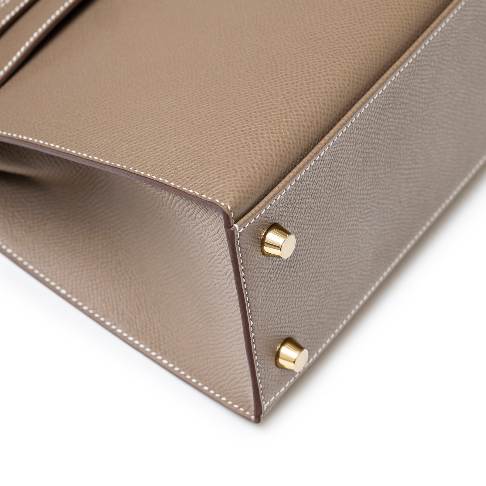 Close-up of Hermès Kelly 25 Sellier Etoupe Epsom Gold Hardware corner and gold feet detail