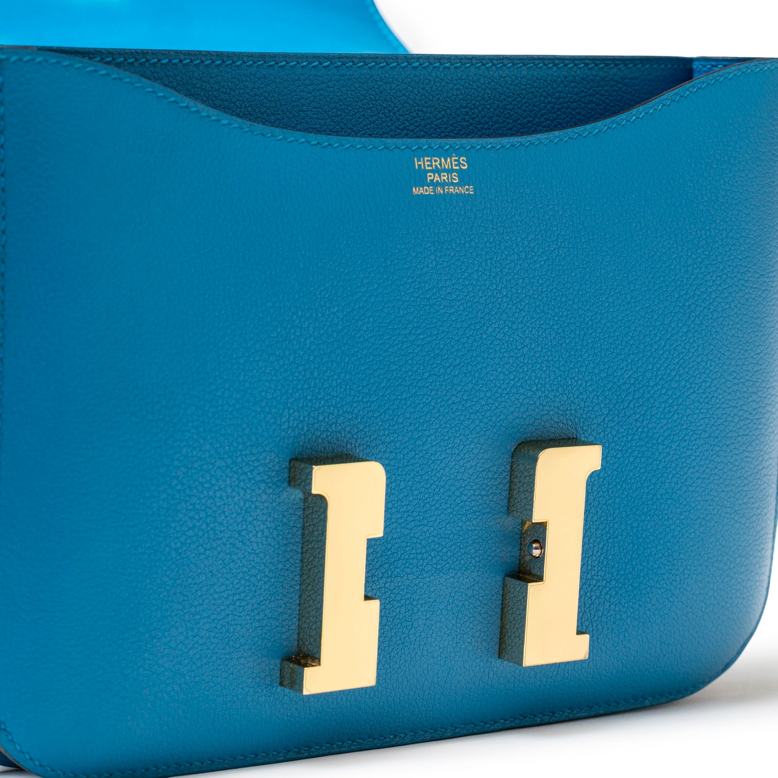 Close-up of front view Hermès Constance 24 Blue Zanzibar Evercolor Gold Hardware H logo and clasp detail