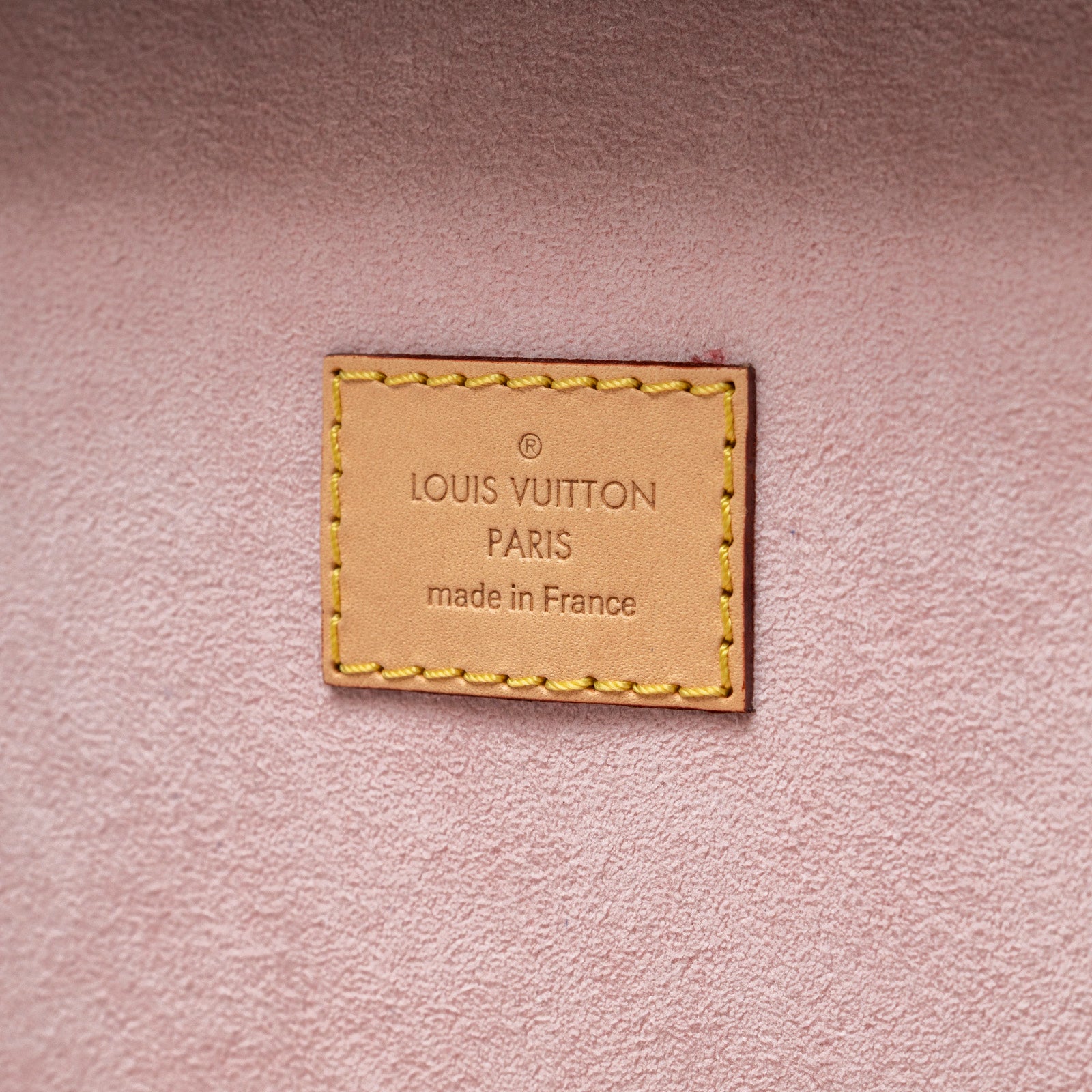 Close-up of Louis Vuitton Coffret Trésor 24 Monogram/Pink Gold Hardware interior label made in France on pink lining