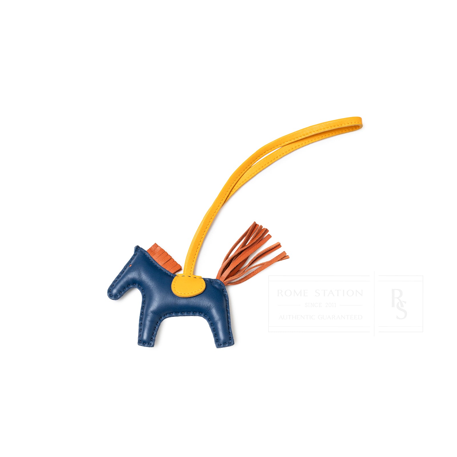 Top view of Hermès Rodeo PM Blue de Malte Cornaline Jaune D'or leather horse charm with yellow strap and tassel tail