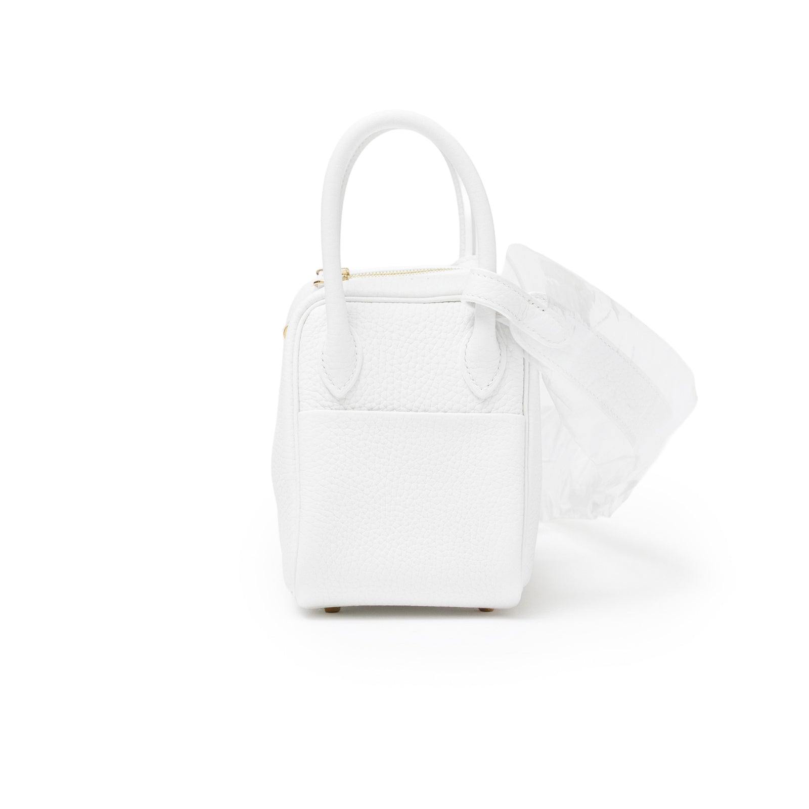 Side view of Hermès Mini Lindy II New White Clemence Gold Hardware showing texture and handle details