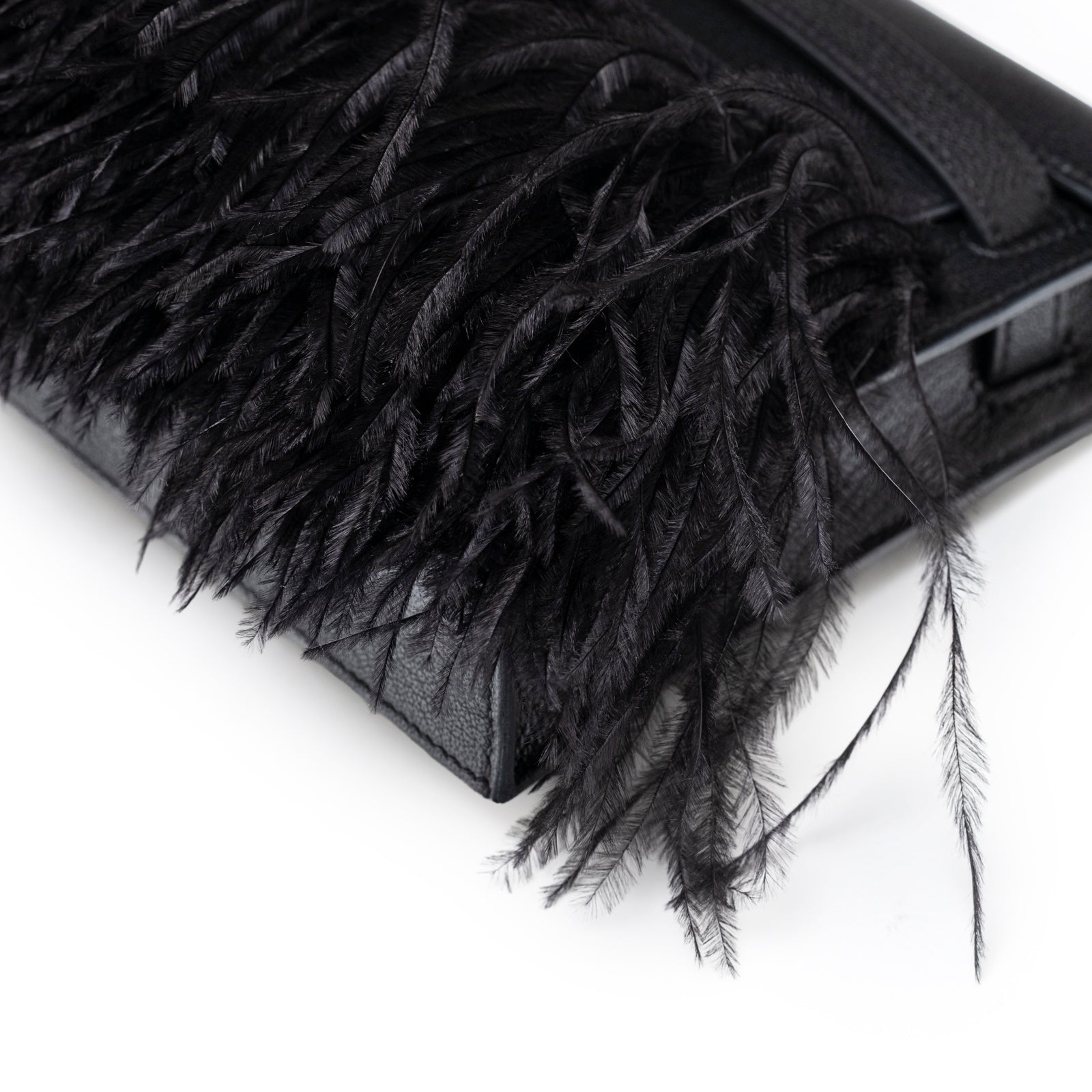 Corner detail of Hermès Kelly Elan Black Chevre Chamkila and Ostrich Feather Palladium Hardware clutch bag