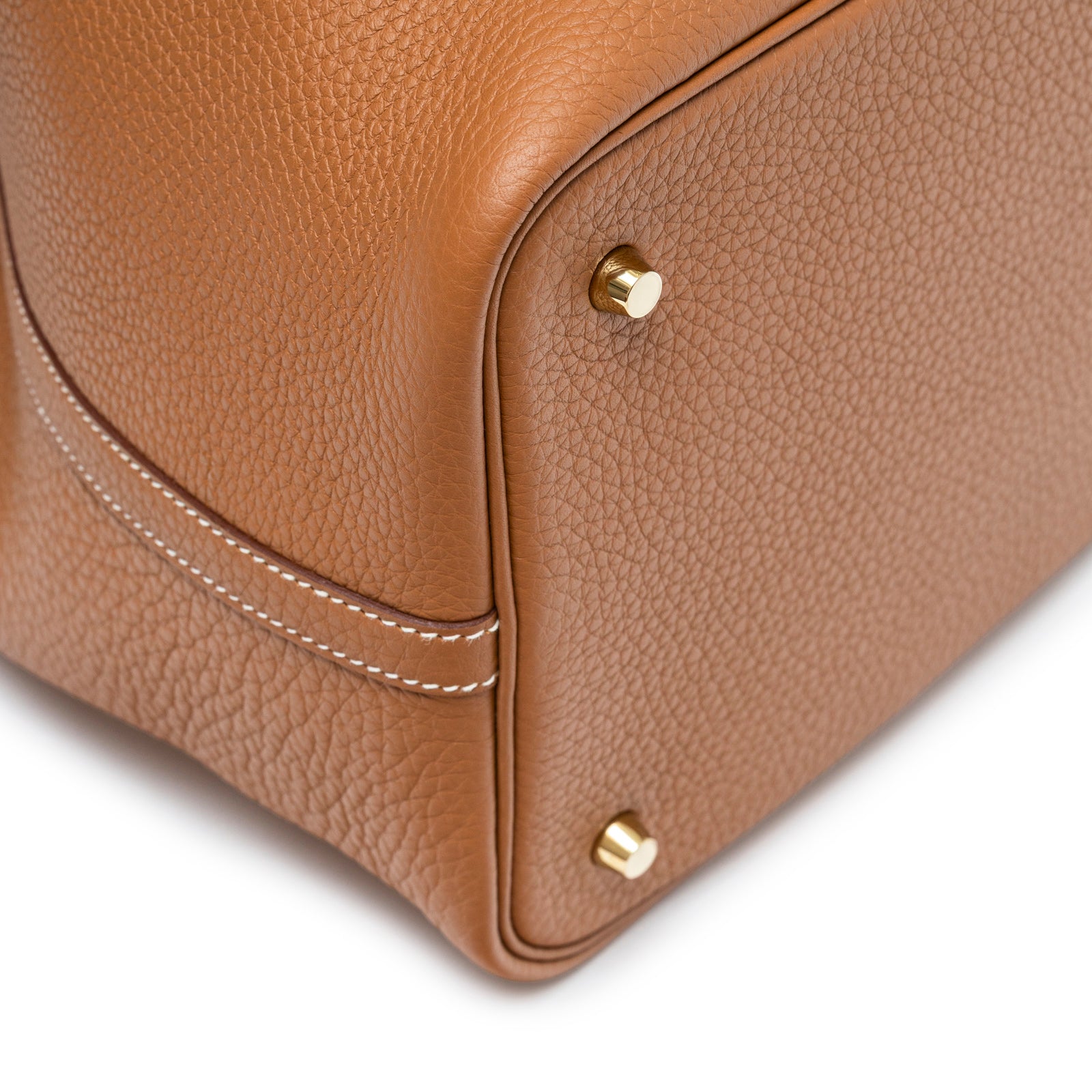 Close-up of bottom corner showing gold hardware and textured Clemence leather on Hermès Picotin 22 Gold Clemence Gold Hardware