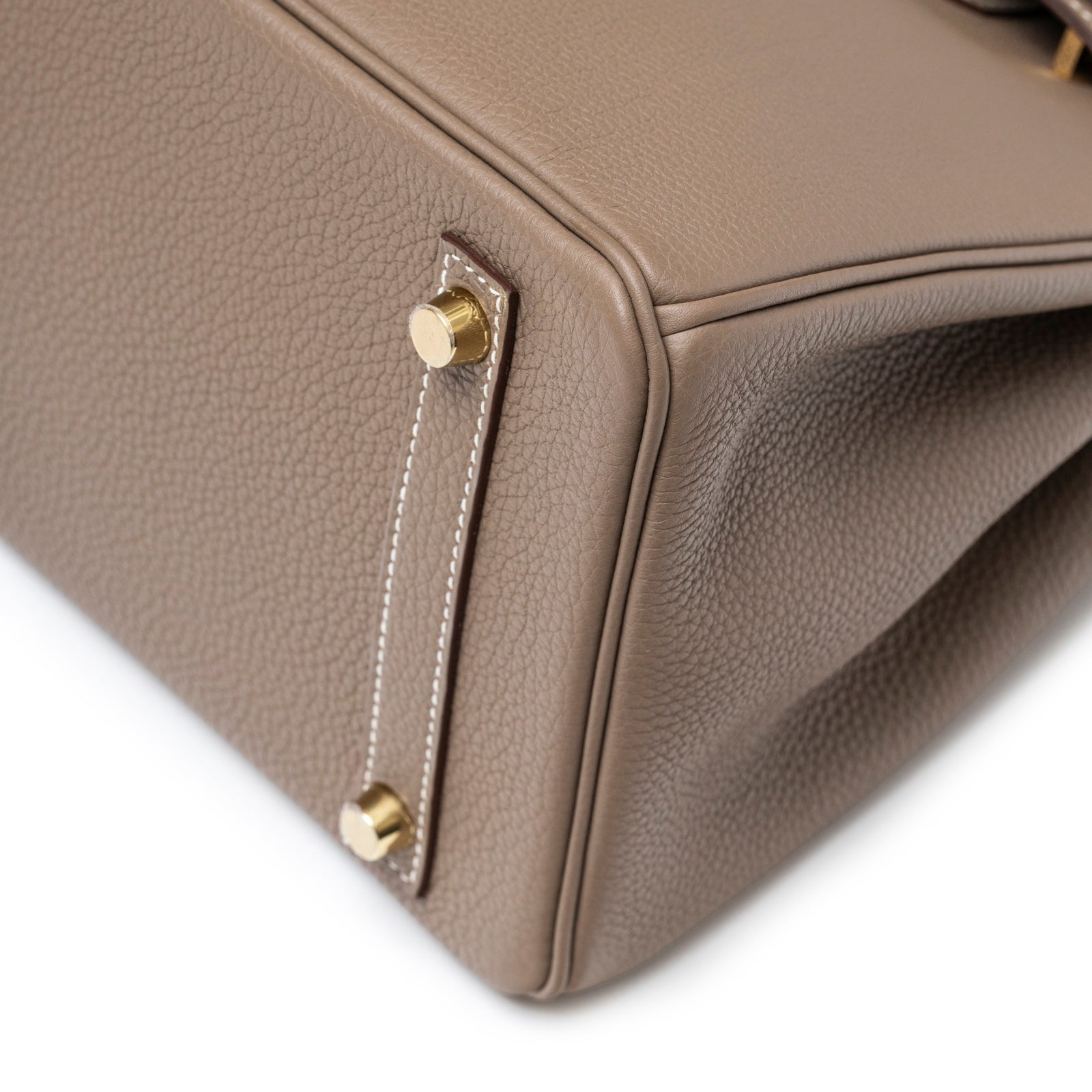 Close-up of bottom corner showing gold feet and Etoupe leather texture on Hermès Birkin 30 Etoupe Togo Gold Hardware bag