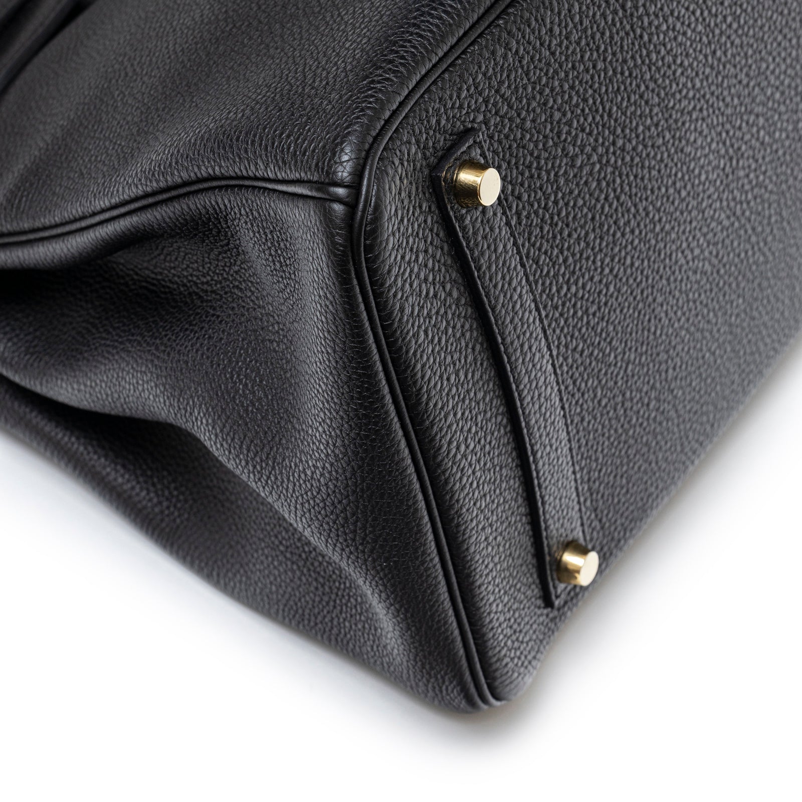 Close-up of Hermès Birkin 35 Black Togo Gold Hardware bottom corner showing leather texture and gold feet details