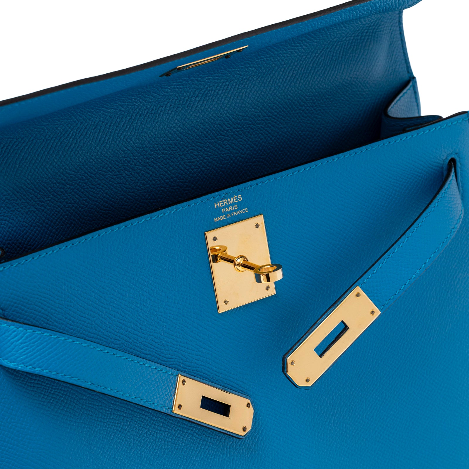 Close-up angled view of Hermès Kelly Sellier 28 Blue Zanzibar Epsom Gold Hardware showing lock and leather texture