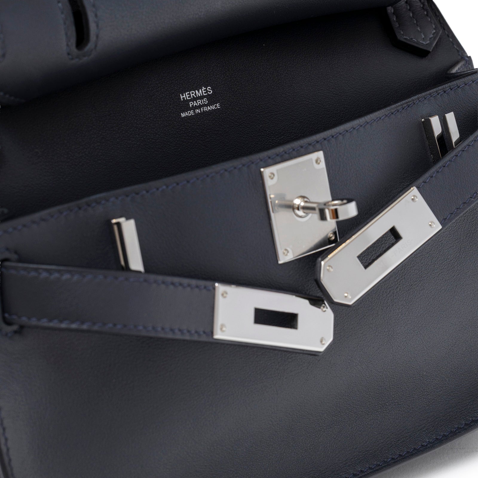 Close-up of the interior and palladium hardware of Hermès Mini Jypsiere Caban Swift Palladium Hardware bag