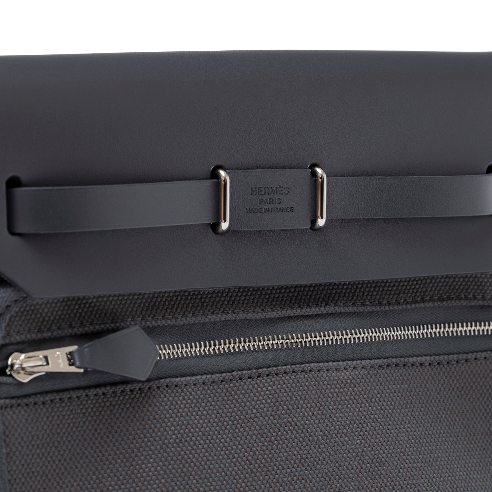 Close-up of Hermès Mini Herbag Zip 20 Ardoise Toile and Vache Hunter Palladium Hardware zipper and leather flap detail