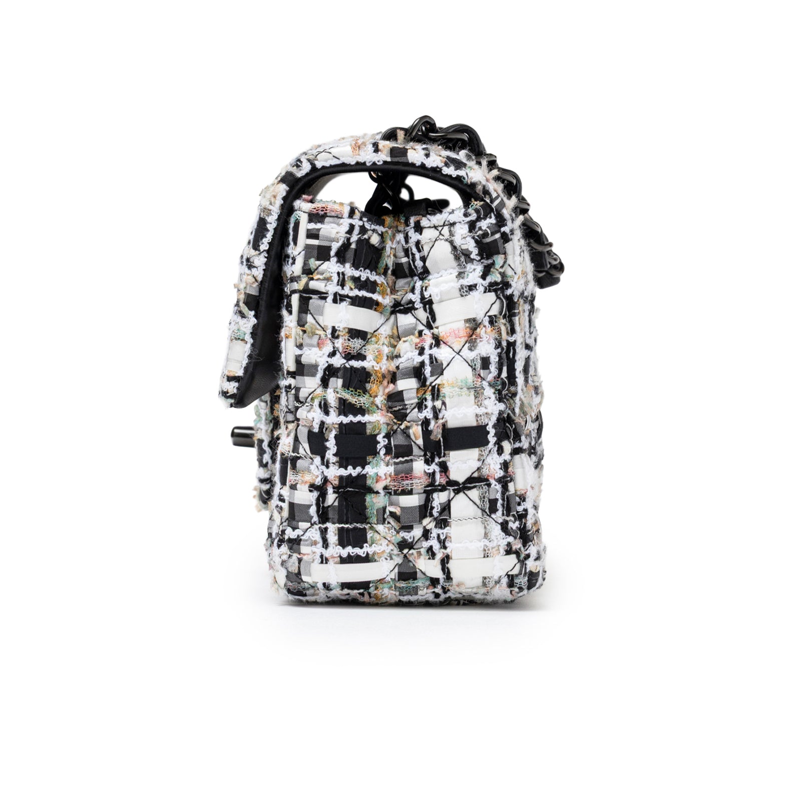 Side profile of Chanel Mini Classic Flap Black and White Tweed Black Hardware showing textured tweed fabric and black hardware details