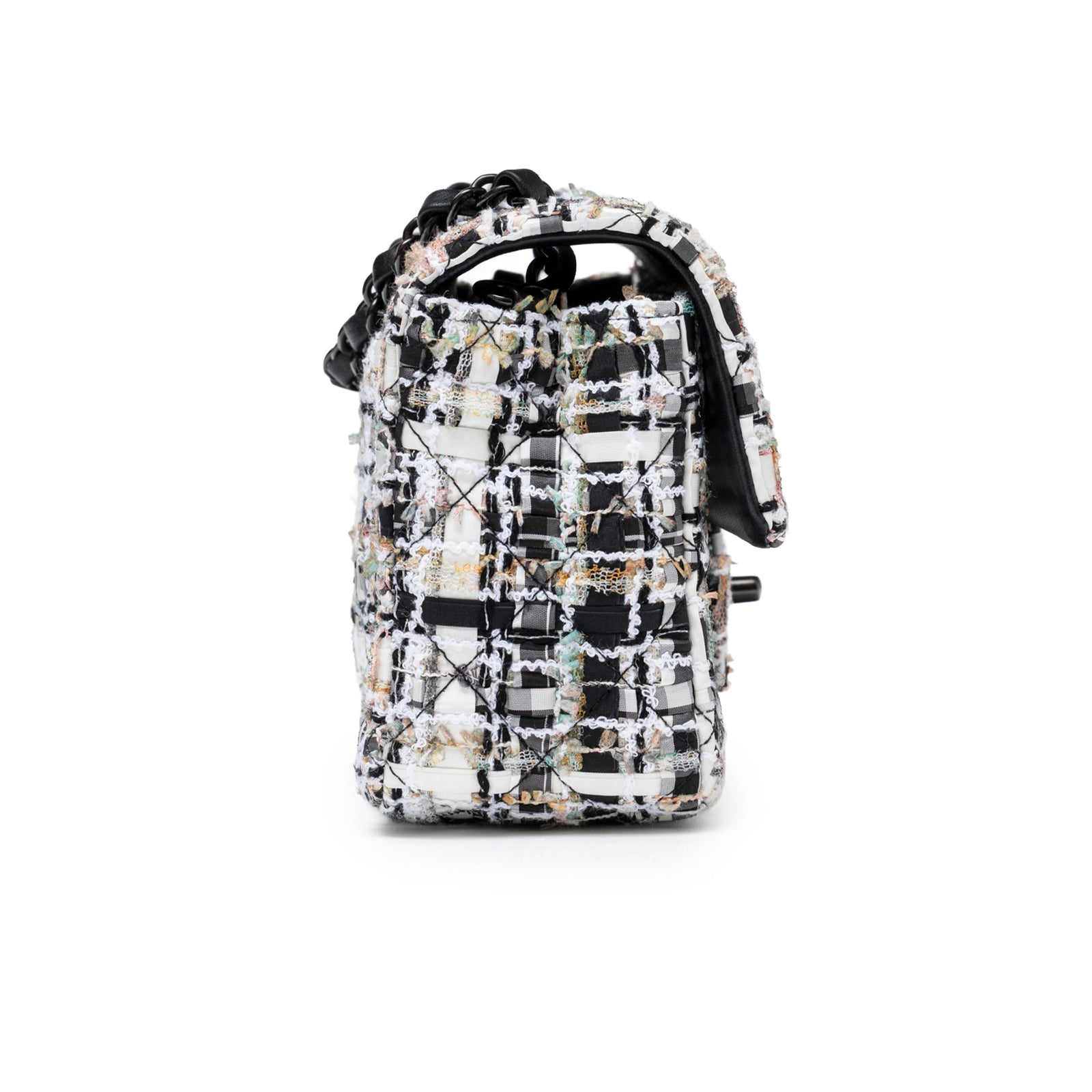 Side view of Chanel Mini Classic Flap Black and White Tweed Black Hardware showcasing textured tweed pattern and chain strap detail