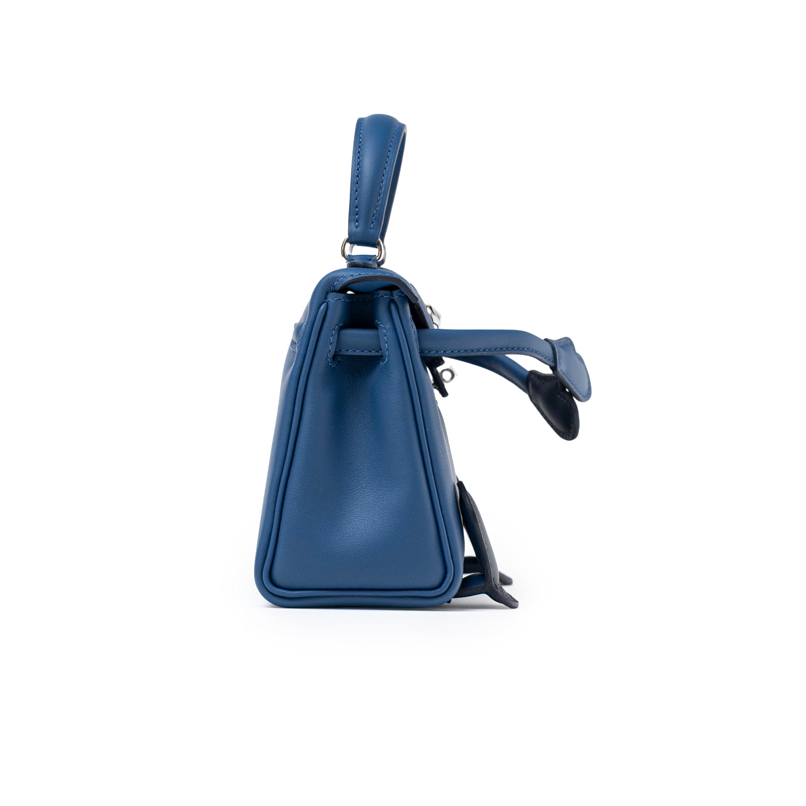 Side profile of Hermès Quelle Idolle Kelly Doll Bleu Tie and Caban Swift Palladium Hardware showing smooth leather and handle detail