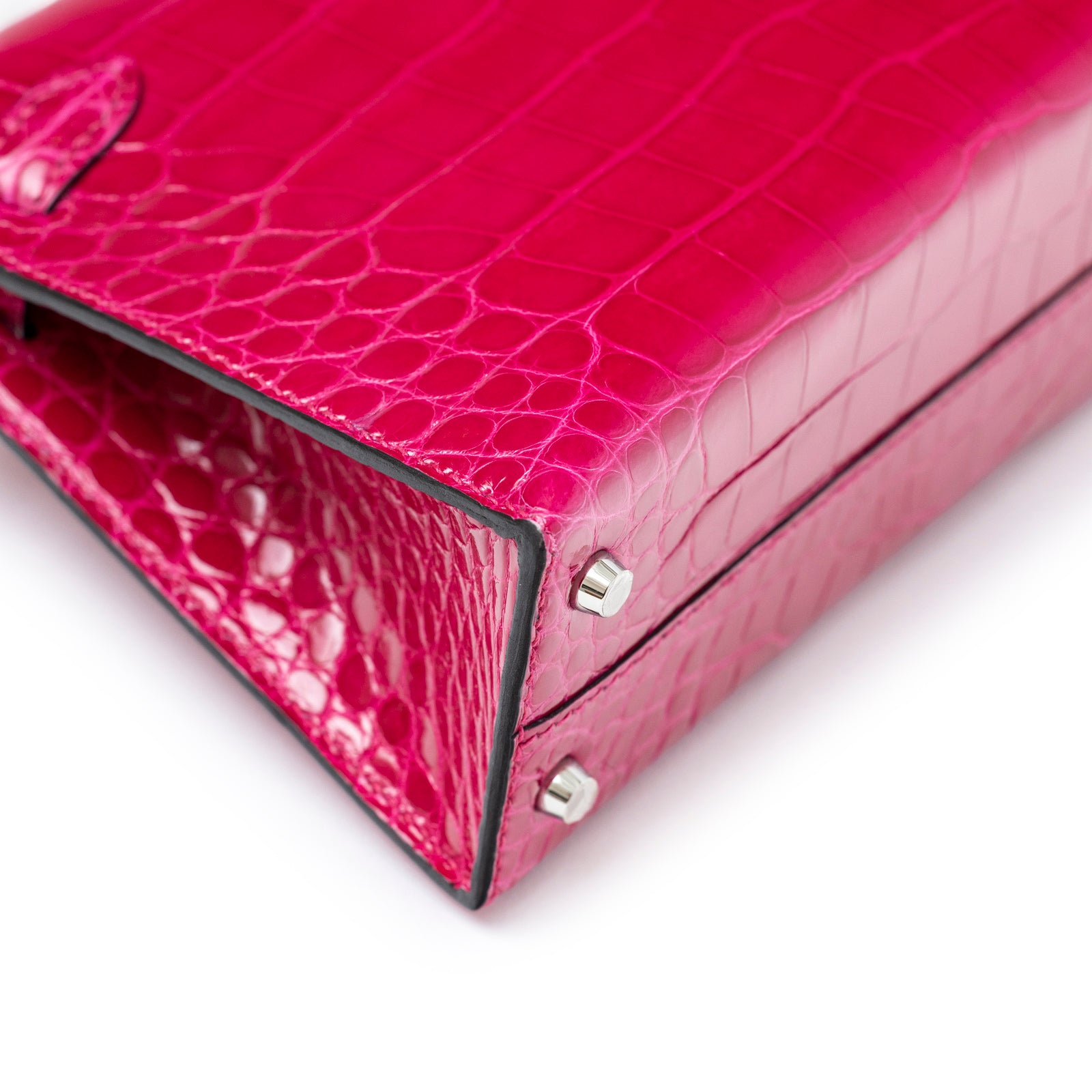 Close-up of bottom corner and palladium hardware feet on Hermès Mini Kelly II Sellier 20 Rose Mexico Shiny Alligator bag
