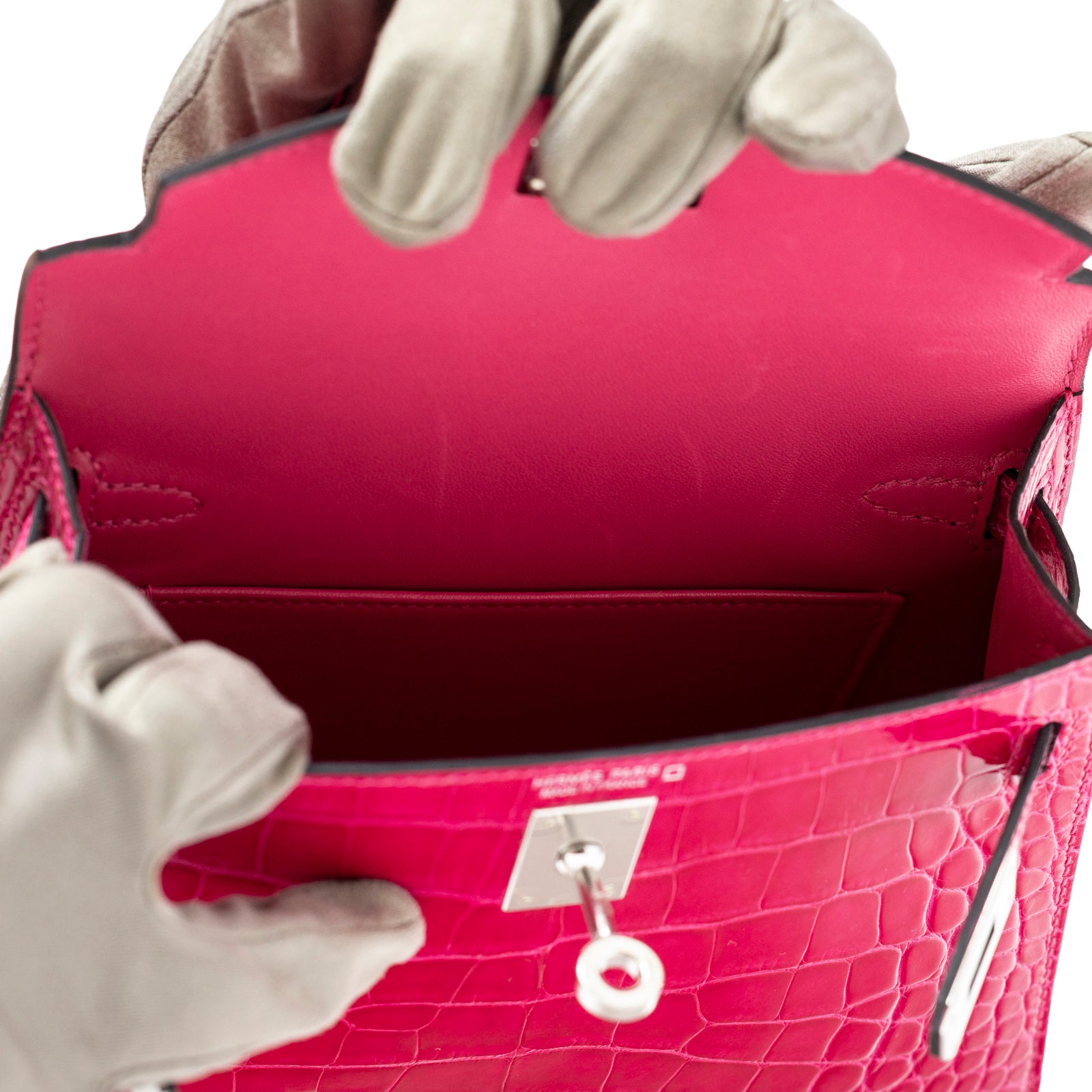 Interior view of Hermès Mini Kelly II Sellier 20 Rose Mexico Shiny Alligator Palladium Hardware handbag showing inner pocket and leather lining