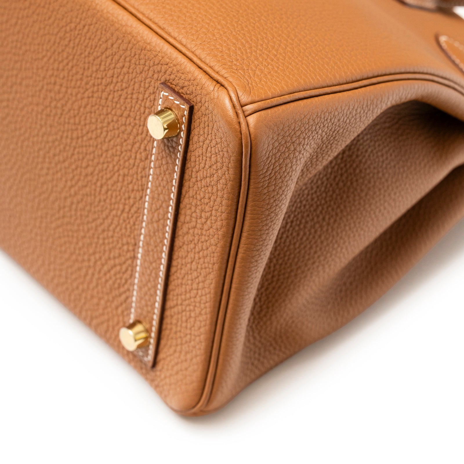 Close-up of bottom corner with gold feet and textured leather on Hermès Birkin 30 Gold Togo Gold Hardware bag