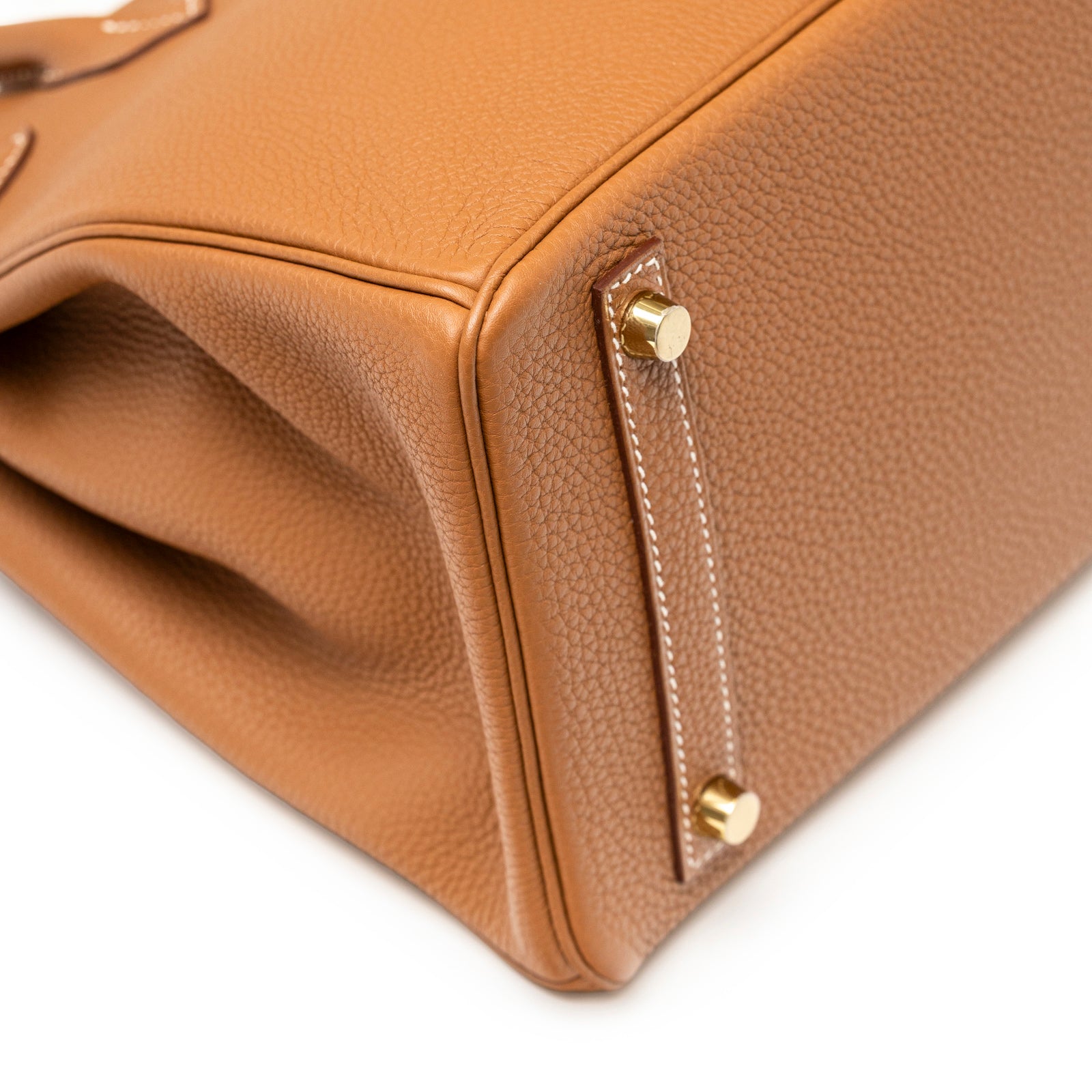 Close-up of bottom corner and gold hardware feet on Hermès Birkin 30 Gold Togo Gold Hardware handbag