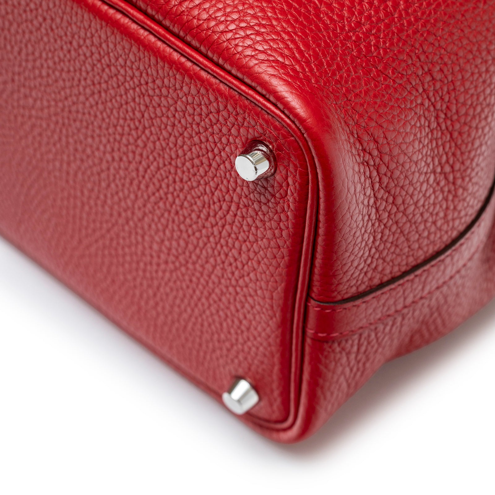 Close-up of bottom corner showing texture and palladium hardware feet on Hermès Picotin 18 Rouge Casaque Clemence Palladium Hardware