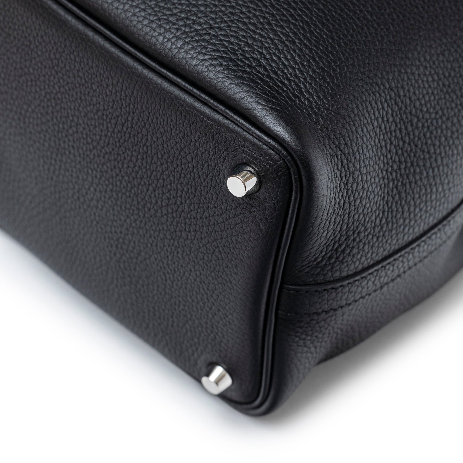 Close-up of bottom corner on Hermès Picotin 18 Black Clemence Palladium Hardware showing leather texture and metal feet