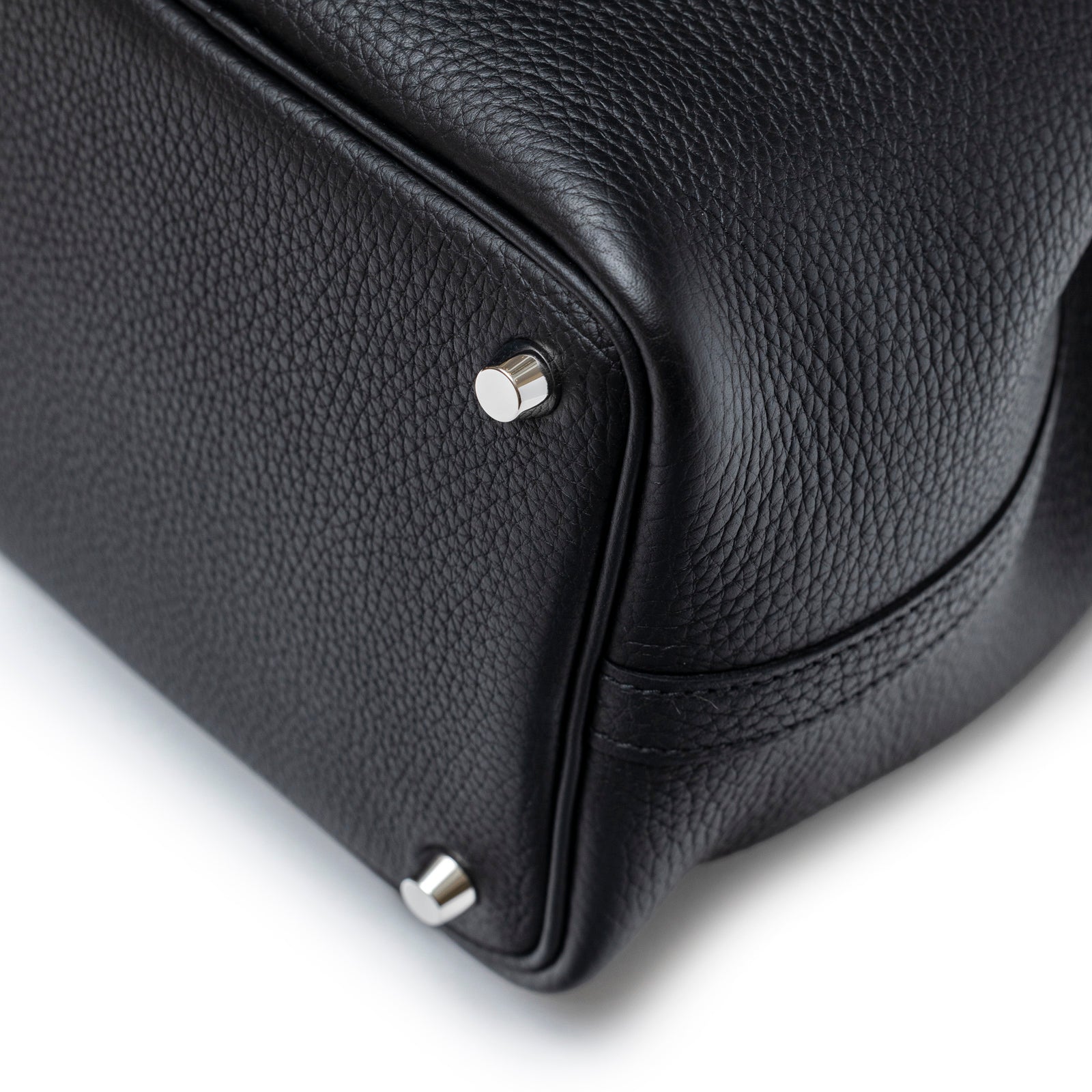 Close-up of bottom corner and palladium feet on Hermès Picotin 18 Black Clemence Palladium Hardware bag