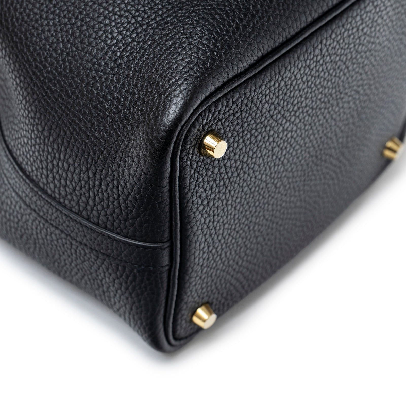 Close-up of bottom corner and gold hardware feet on Hermès Picotin 18 Black Clemence Gold Hardware bag