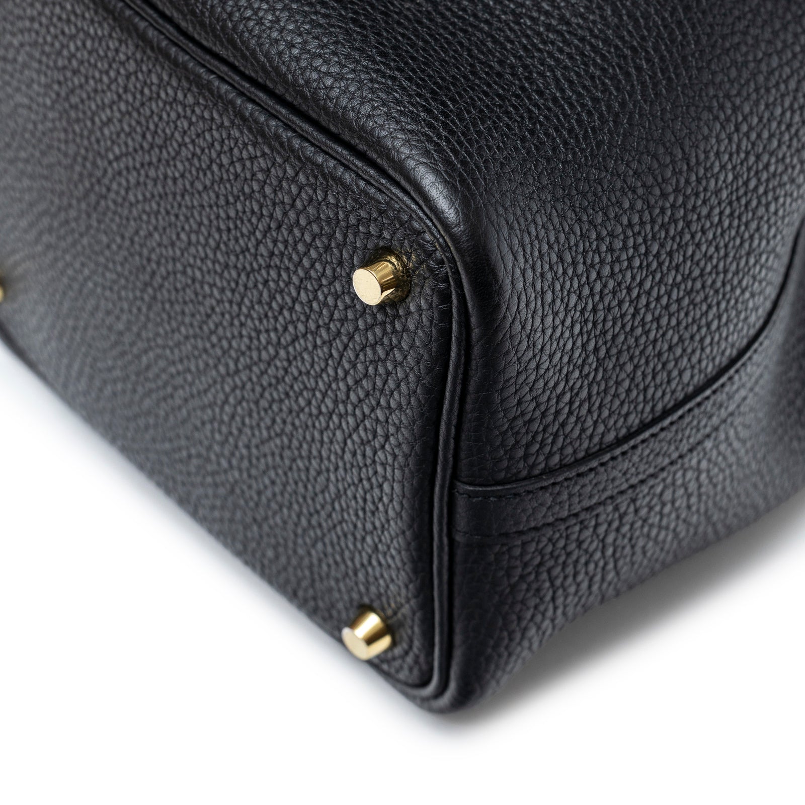 Close-up of bottom corner and gold hardware feet on Hermès Picotin 18 Black Clemence Gold Hardware bag