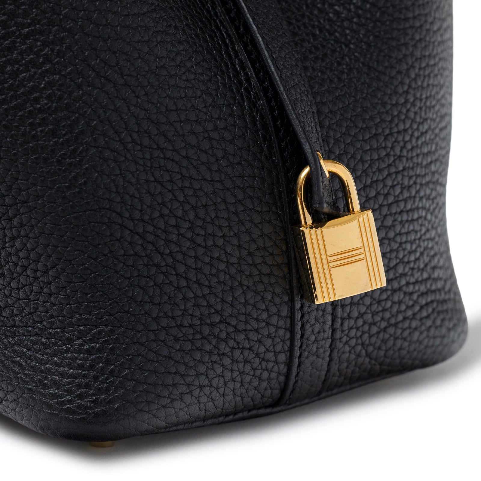 Close-up of gold padlock and textured leather detail on Hermès Picotin 18 Black Clemence Gold Hardware bag