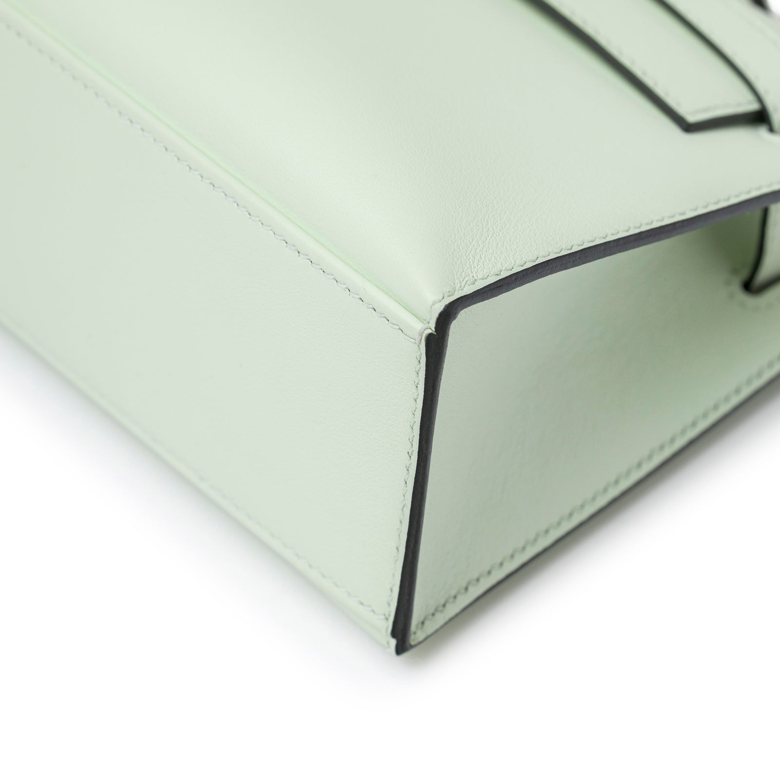 Close-up of bottom corner stitching and smooth leather on Hermès Kelly Pochette Vert Fizz Swift Palladium Hardware bag