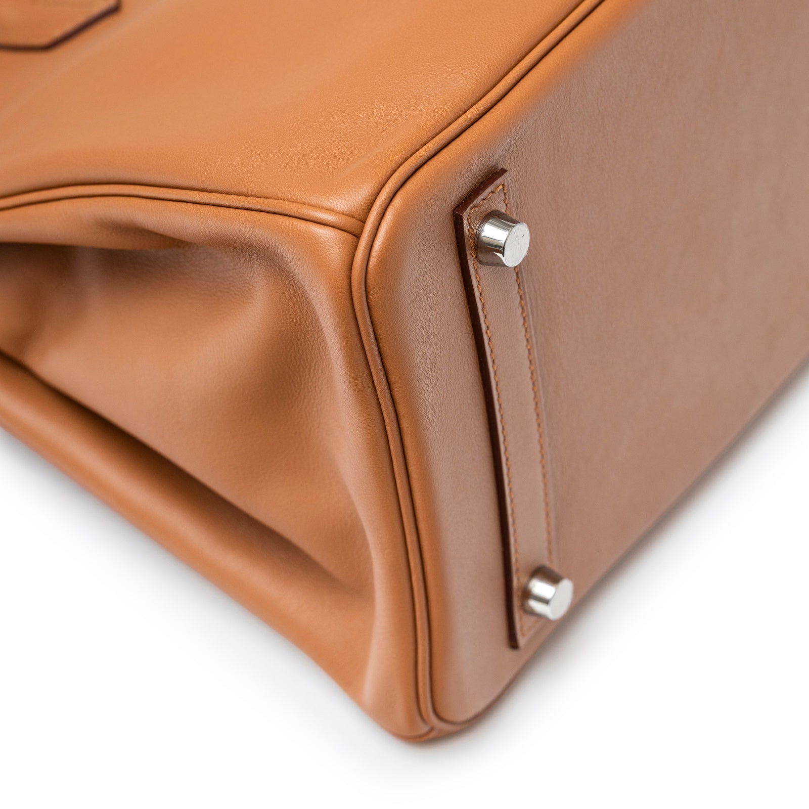 Close-up of bottom corner and palladium hardware feet on Hermès Birkin 30 Tressage Gold/Blue Du Nord/Blue Indigo Swift/Epsom Palladium Hardware bag